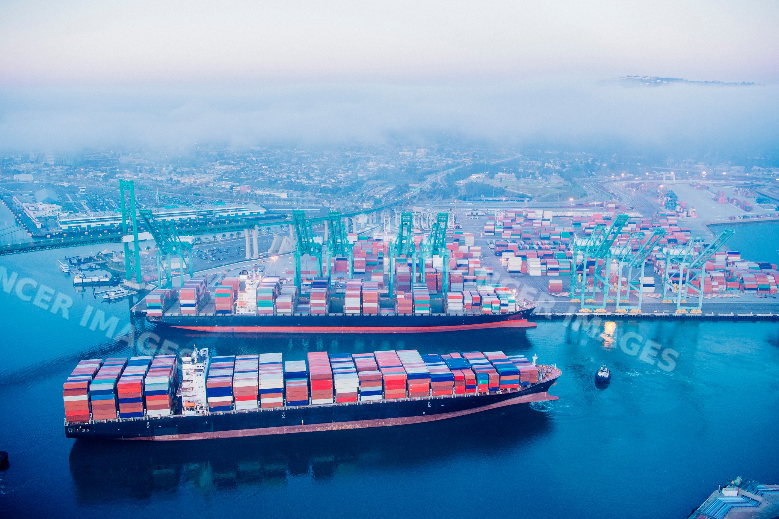 Two container ships docked at port terminal in a beach