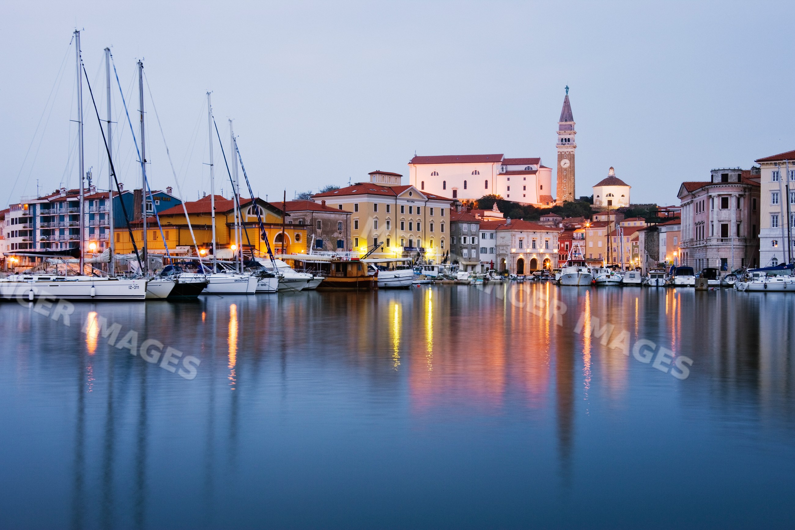 Town of piran waterfront with sailboats and historic buildings