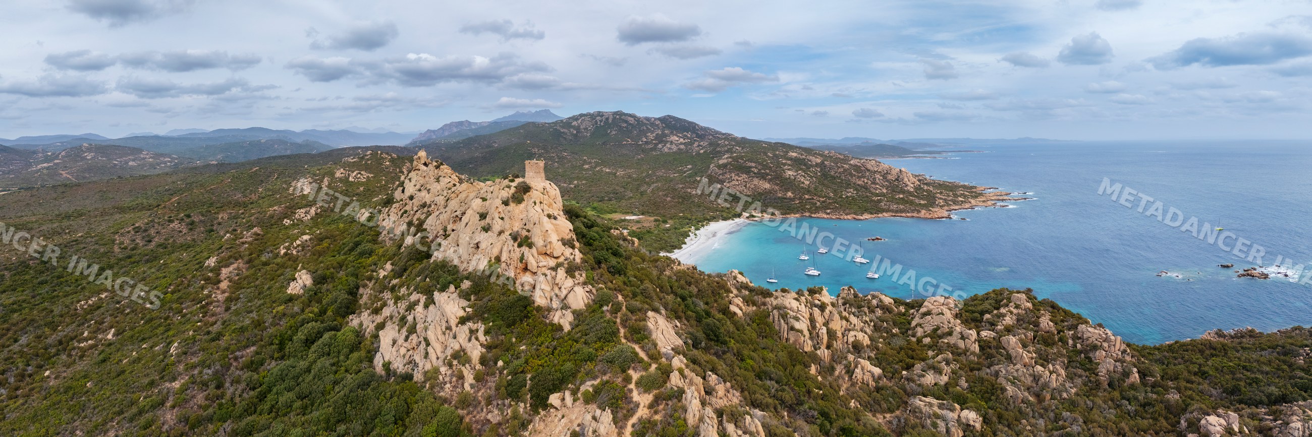 Genoese tower overlooking cala di roccapina bay in corsica, france
