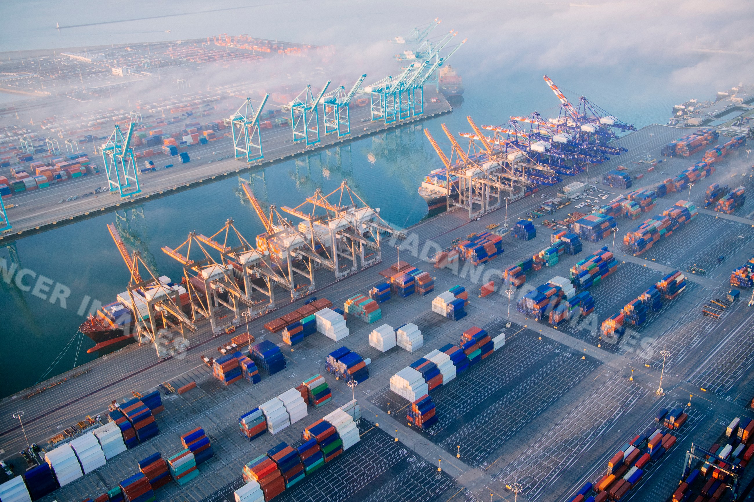 Container terminal at the port with cranes and cargo ships