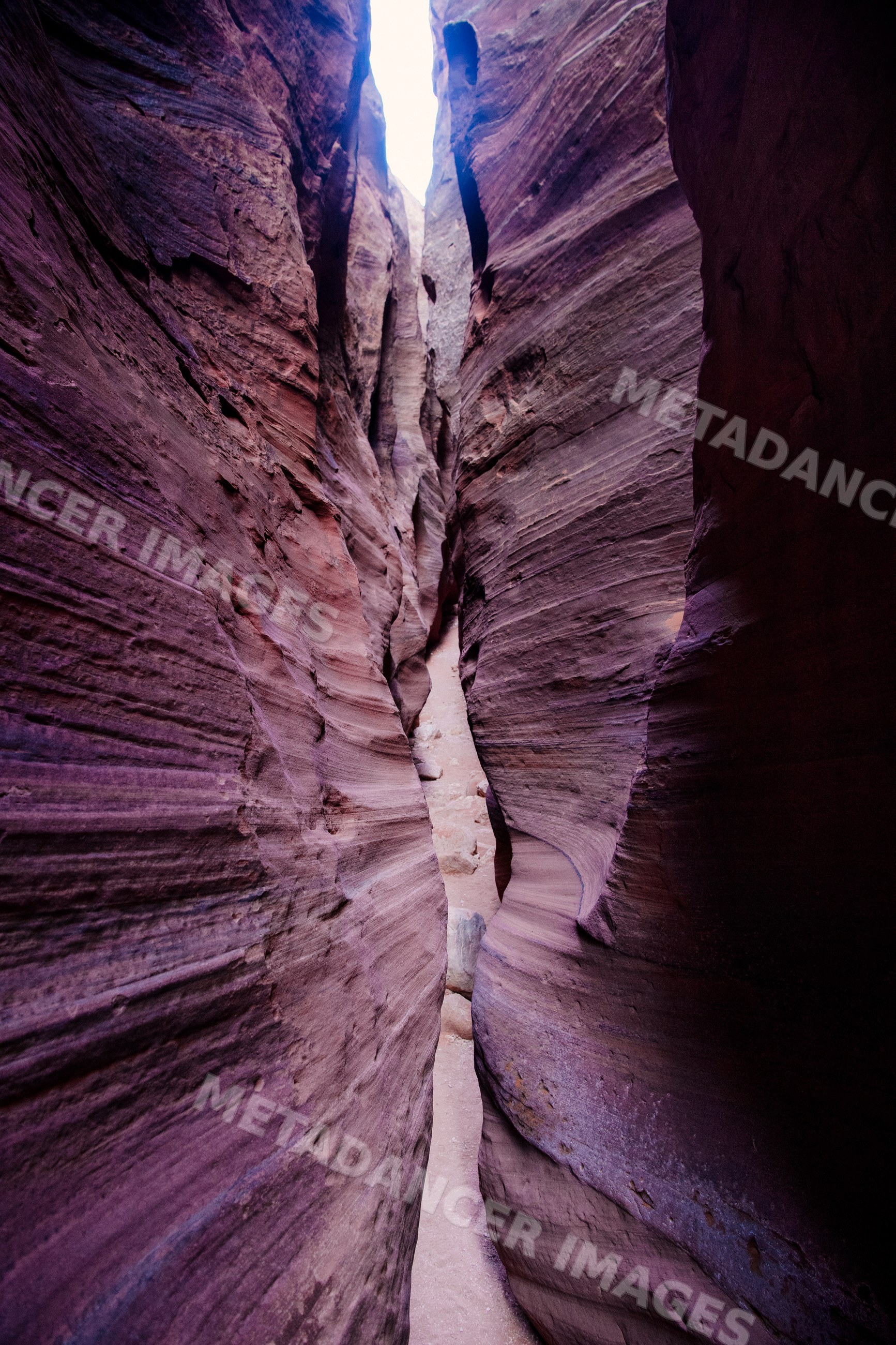 Narrow slot canyon with layered rock walls