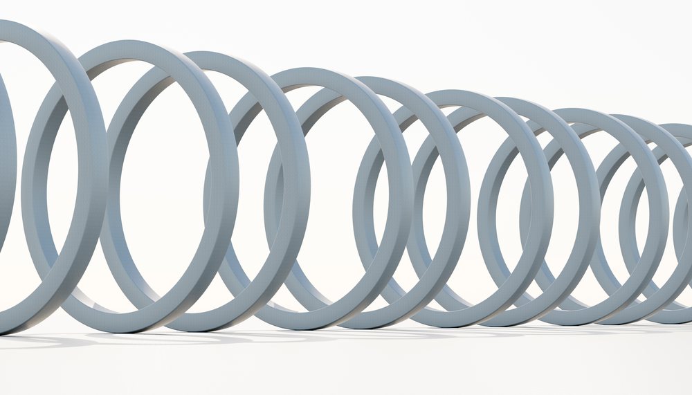 Close-up of a coiled metal spring isolated on a white background