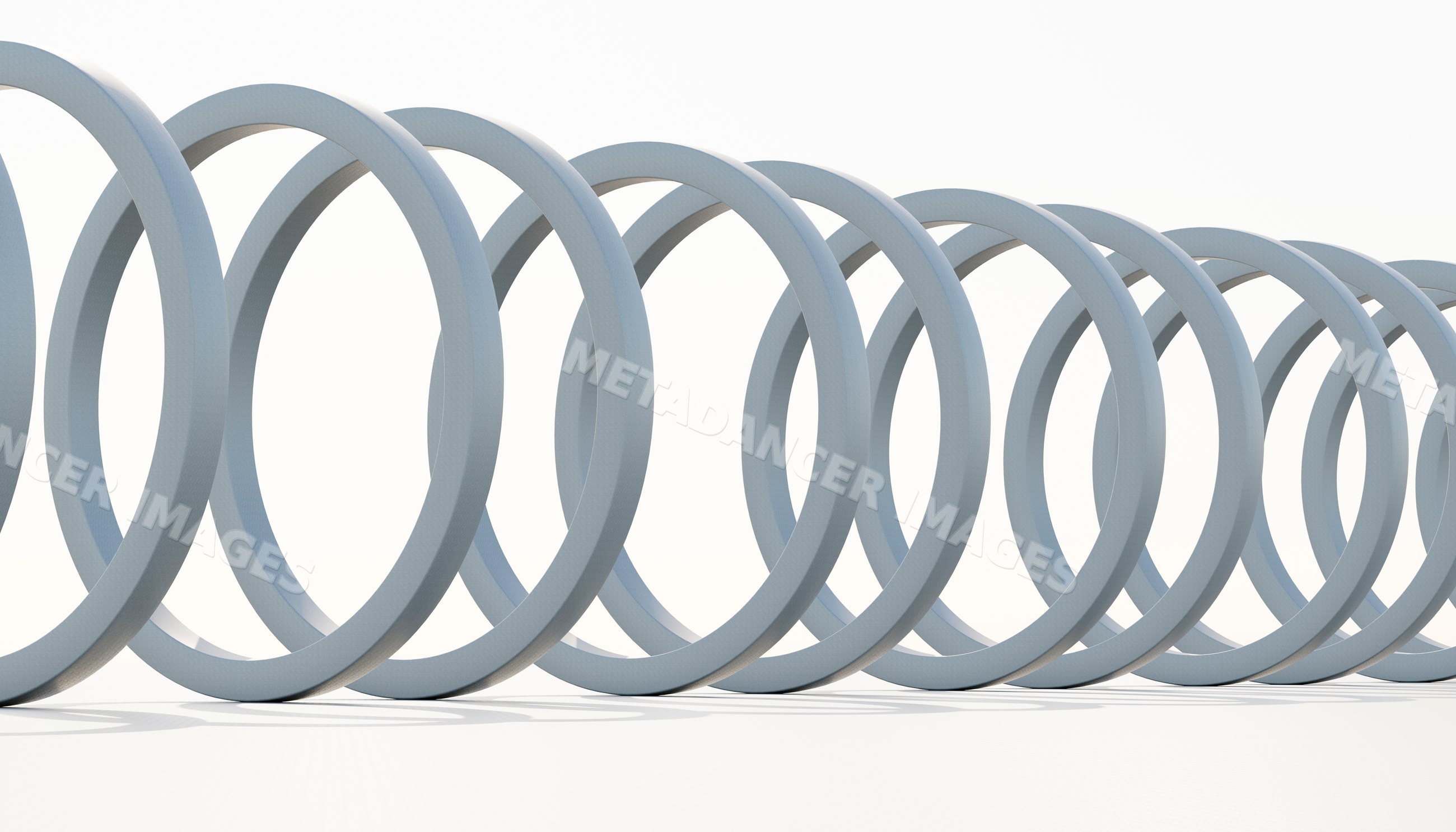 Close-up of a coiled metal spring isolated on a white background