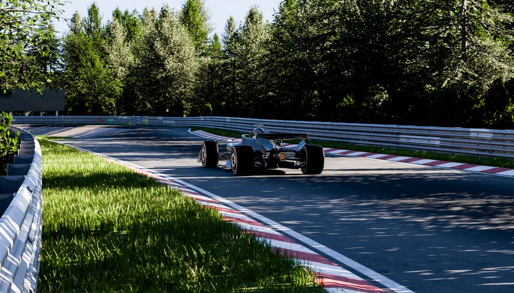 A race car drives on a curved track through a forested race circuit