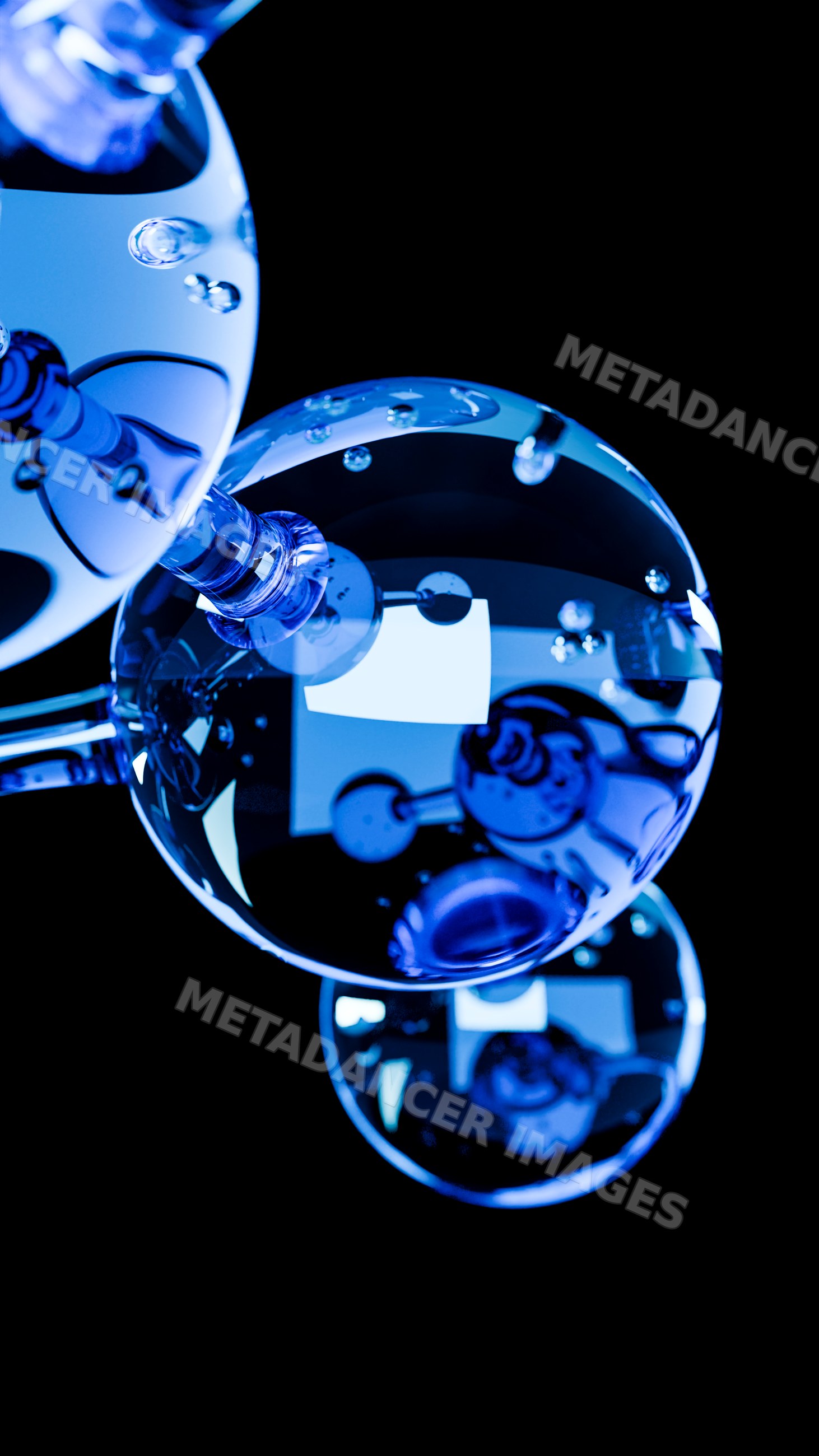 Close-up of blue transparent glass spheres with water droplets