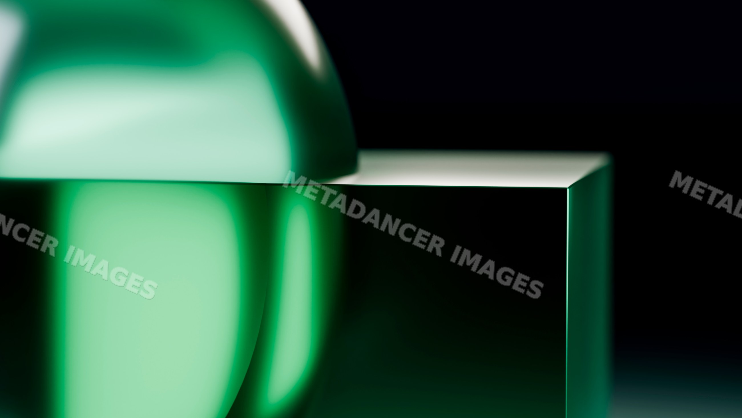 Green glass sphere on a reflective glass block