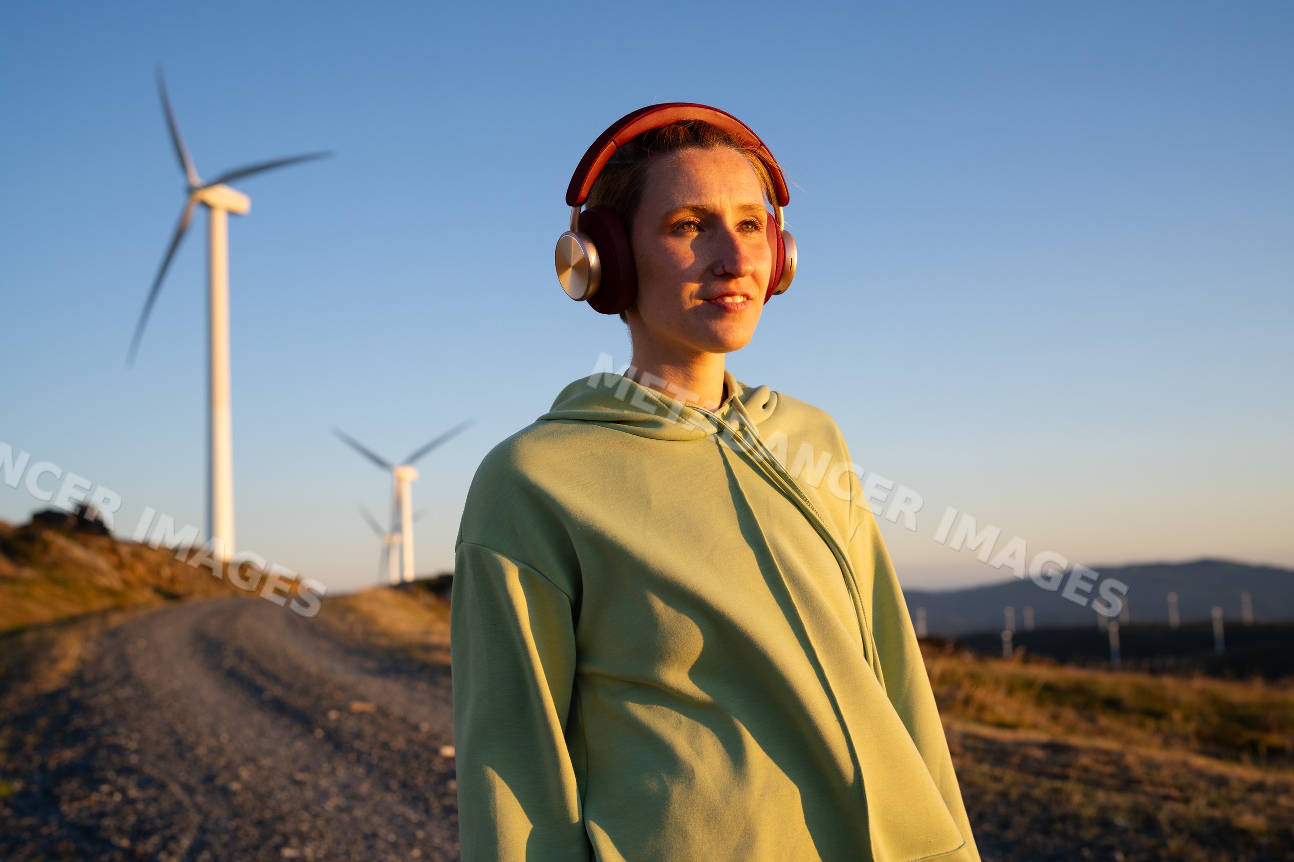 A white woman enjoys music outdoors
