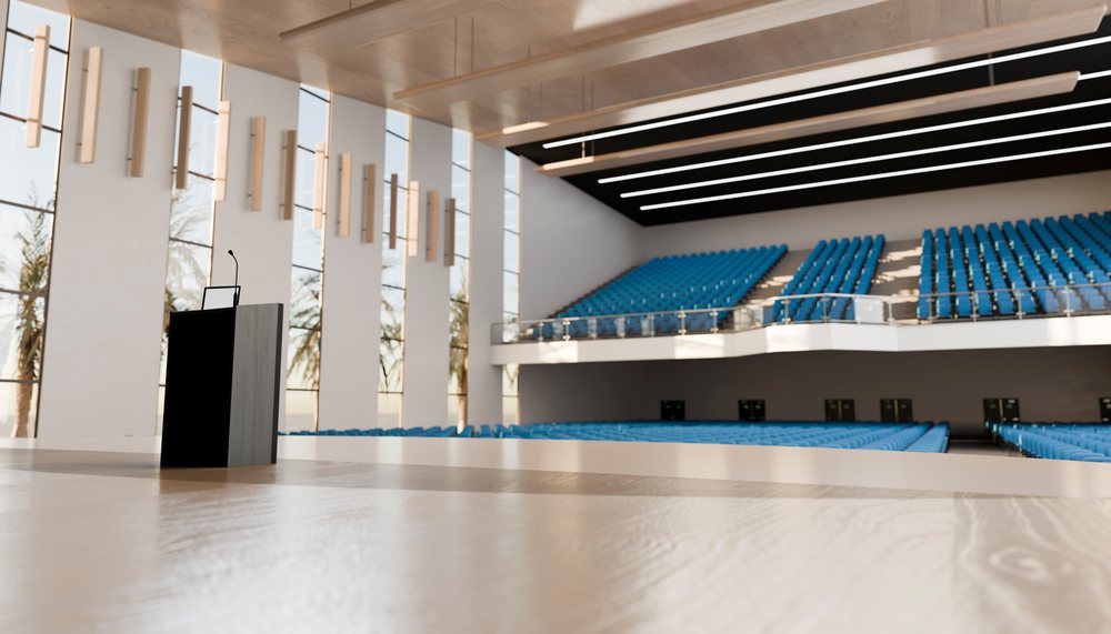 Lecture hall with podium and blue auditorium seating