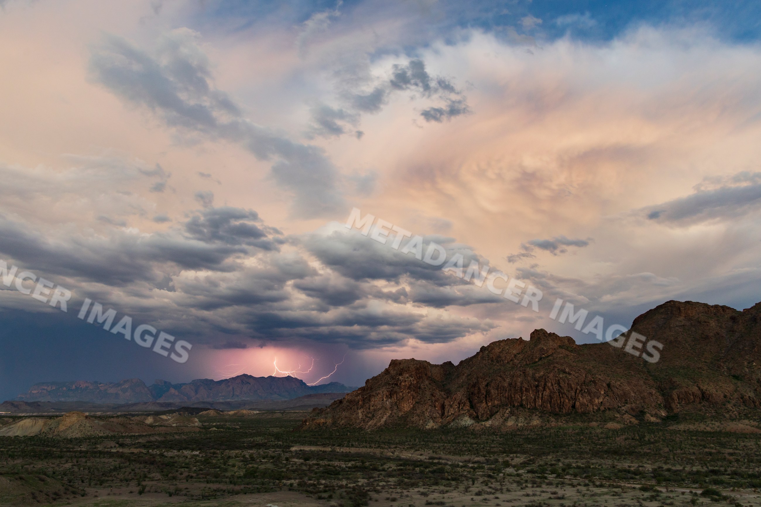 Lightning striking over Chisos Mountains in a park