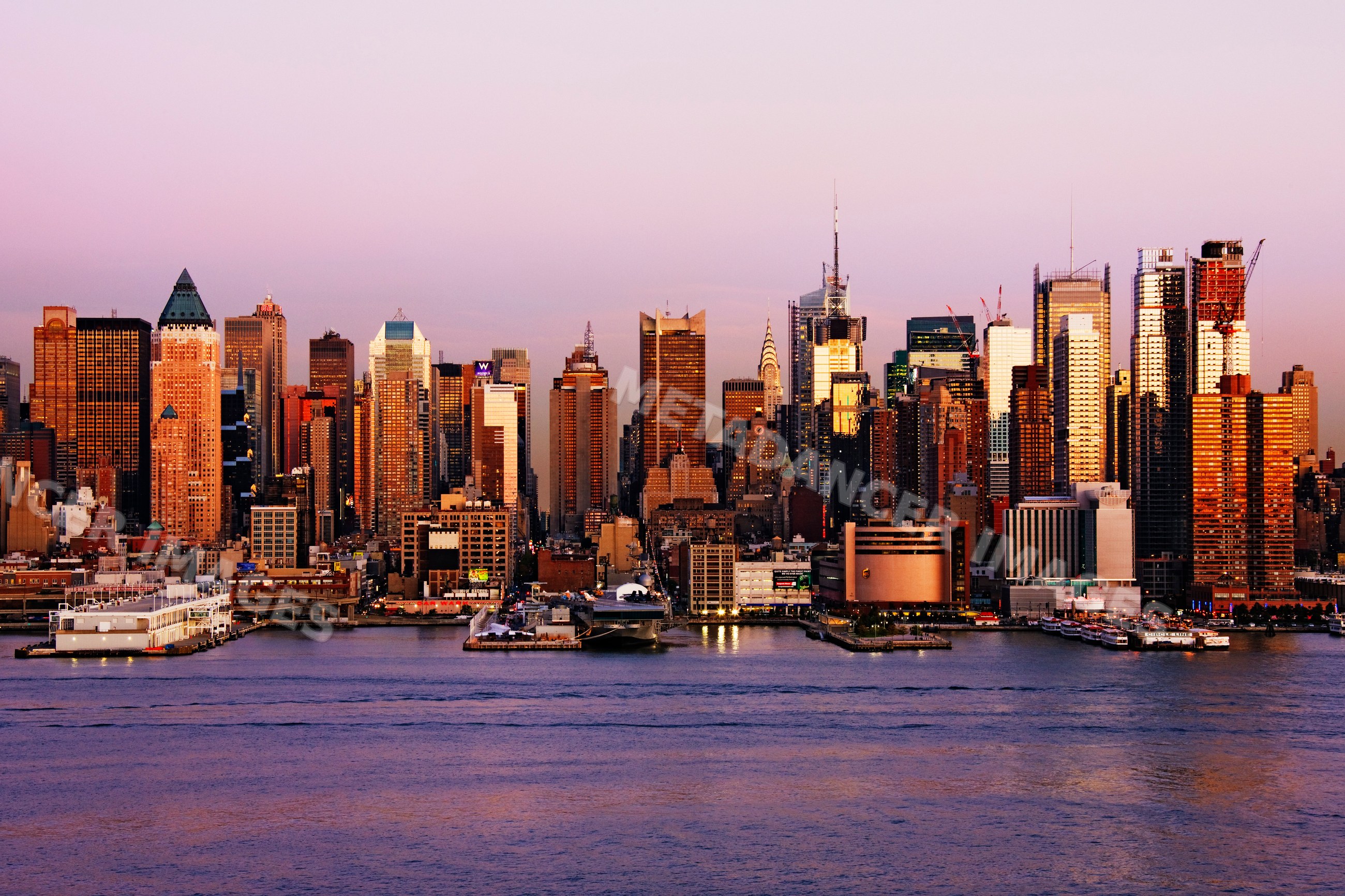 Midtown manhattan skyline at dusk along the hudson river