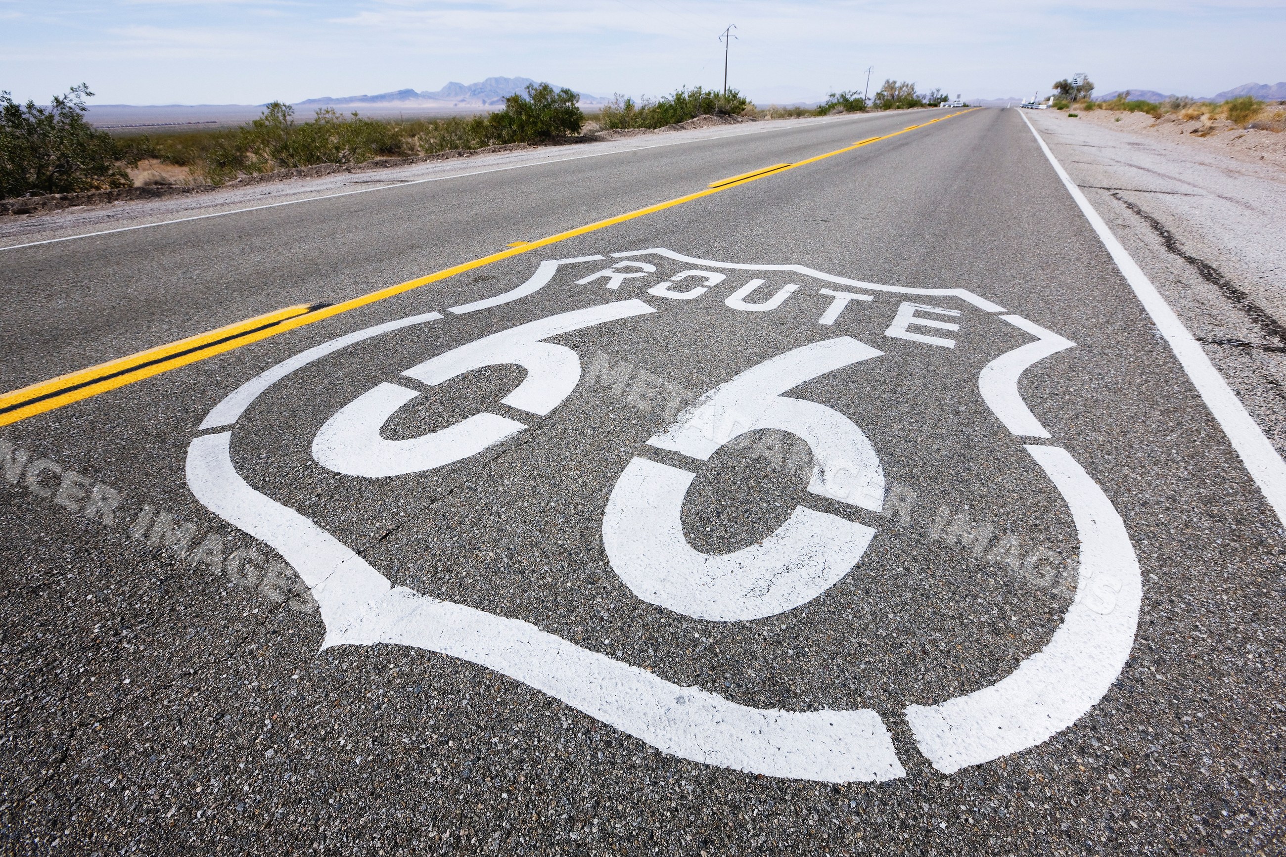 Route 66 road marking on desert highway USA