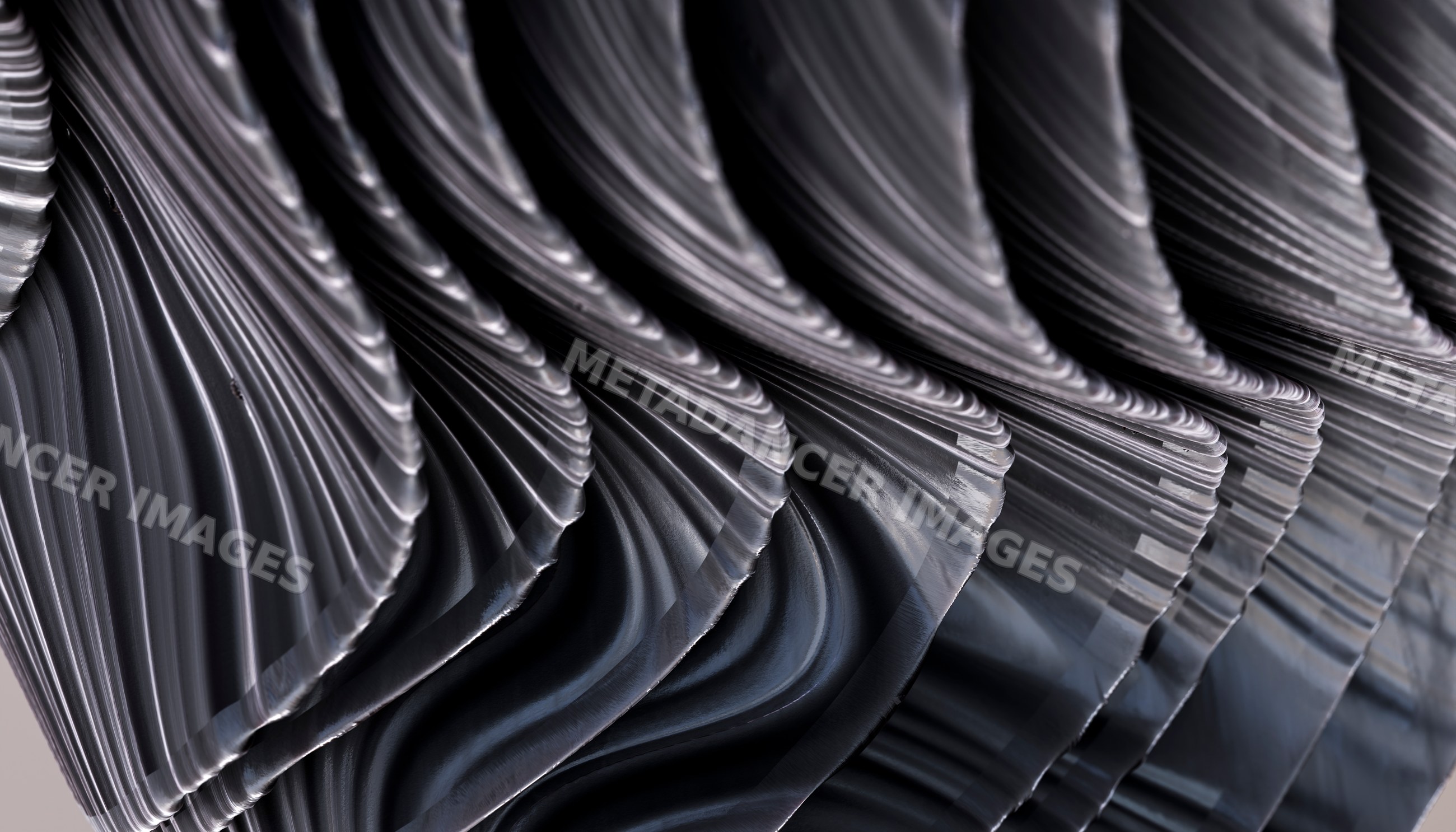 Abstract wavy black metal sculpture with reflective curved surfaces