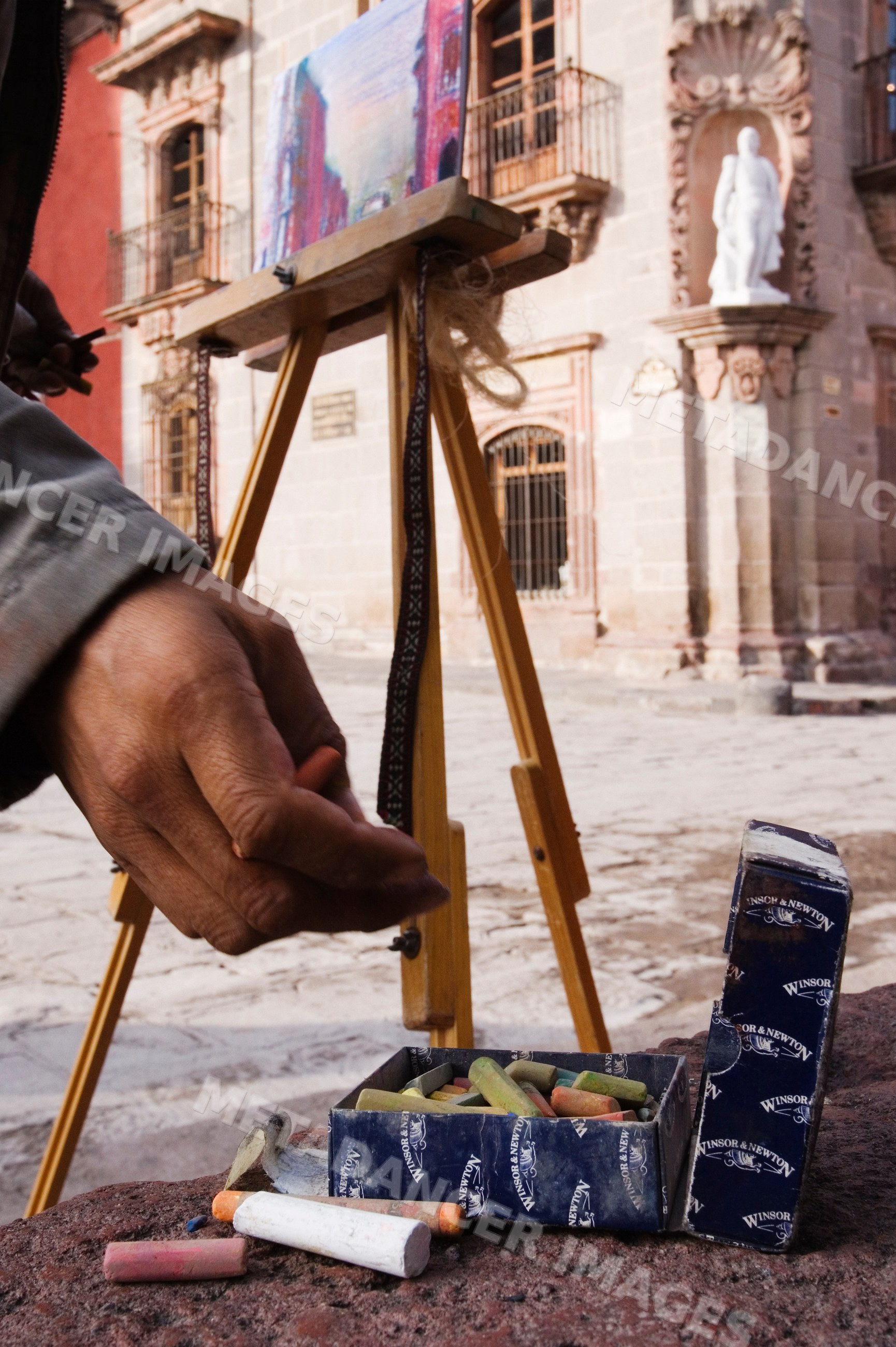 Artist's hand drawing with chalk pastels