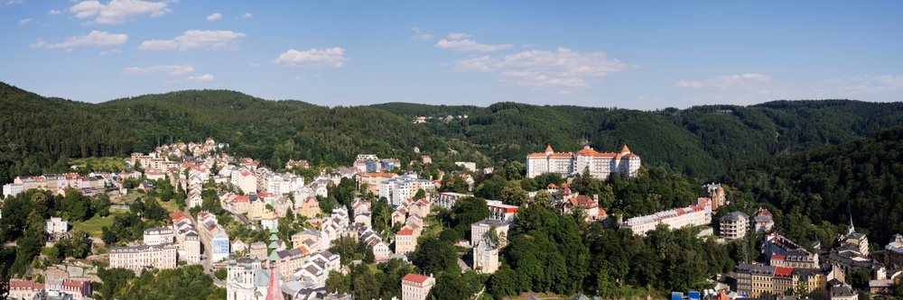 Panoramic townscape of karlovy vary with forested hills