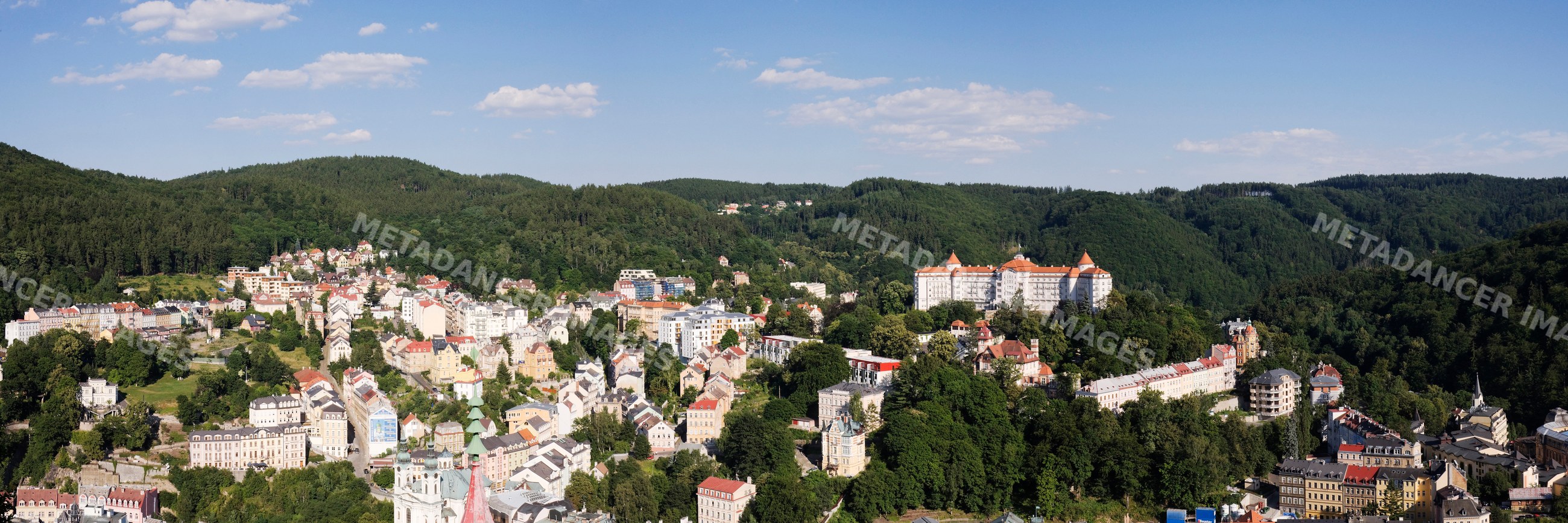 Panoramic townscape of karlovy vary with forested hills