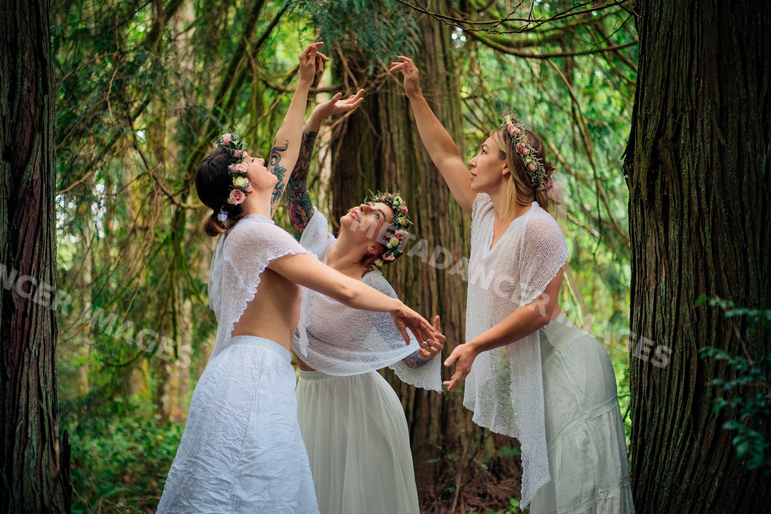 White women dancing with flower crowns in a wooded forest