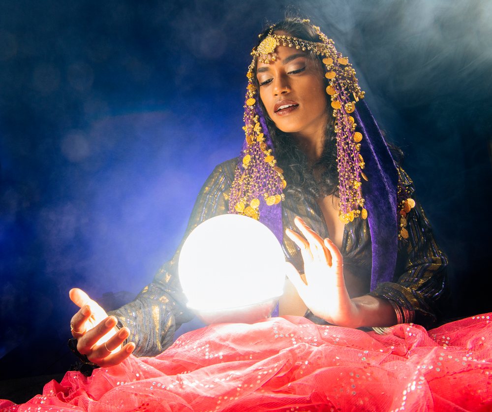 A South Asian woman fortune teller gazes