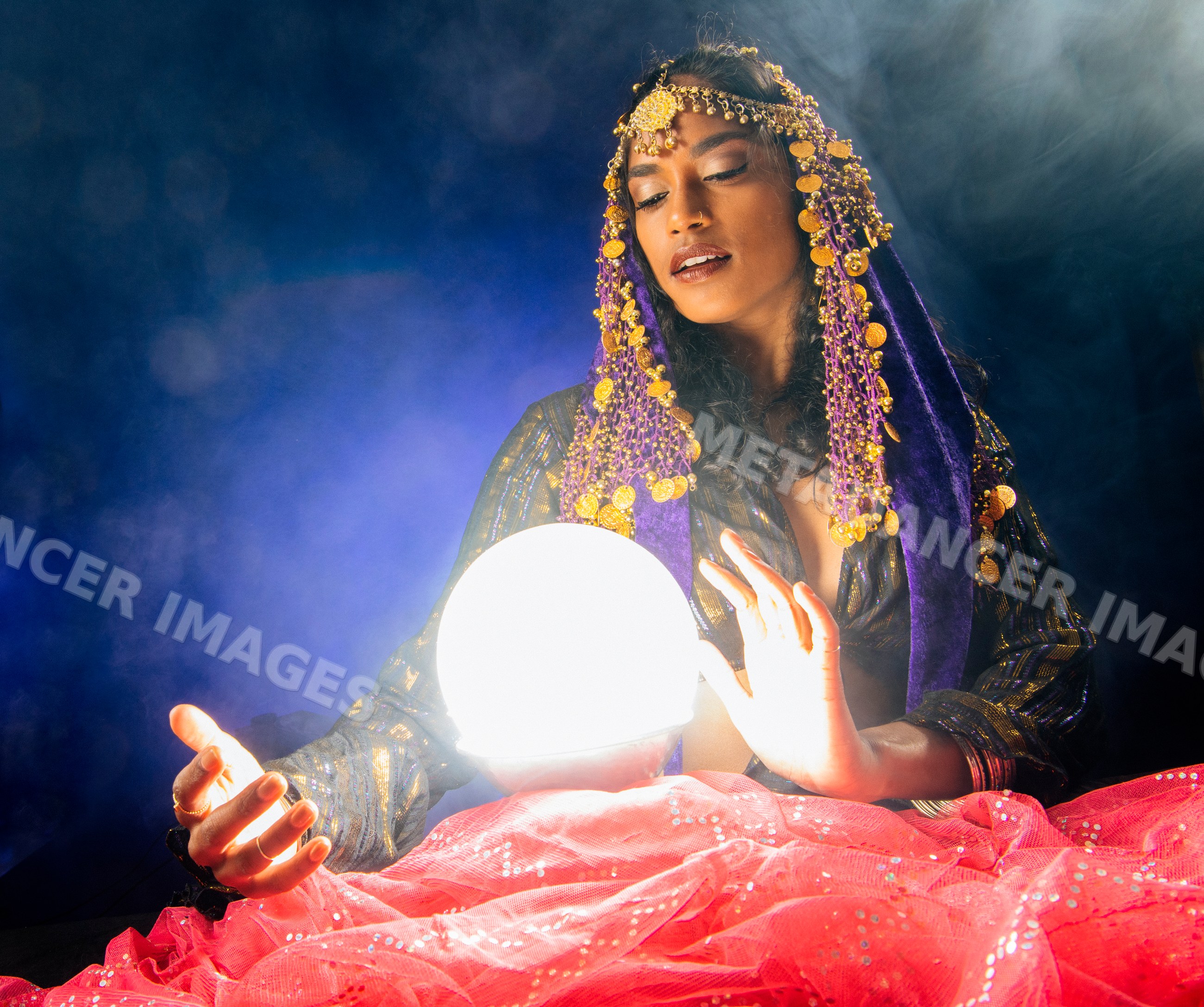 A South Asian woman fortune teller gazes