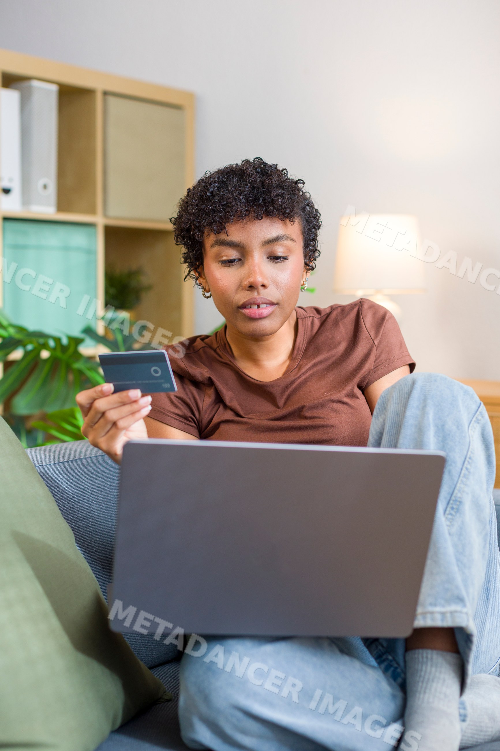 Young African American woman using laptop and credit card
