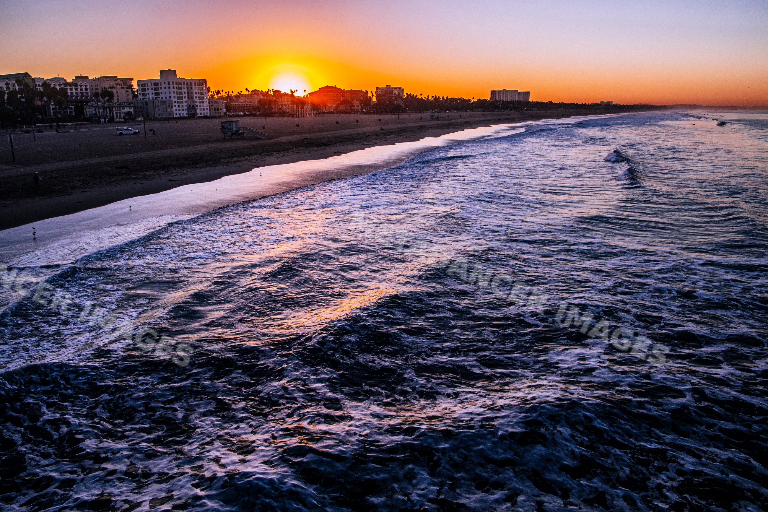 Sunset over Santa Monica beach and ocean waves in california