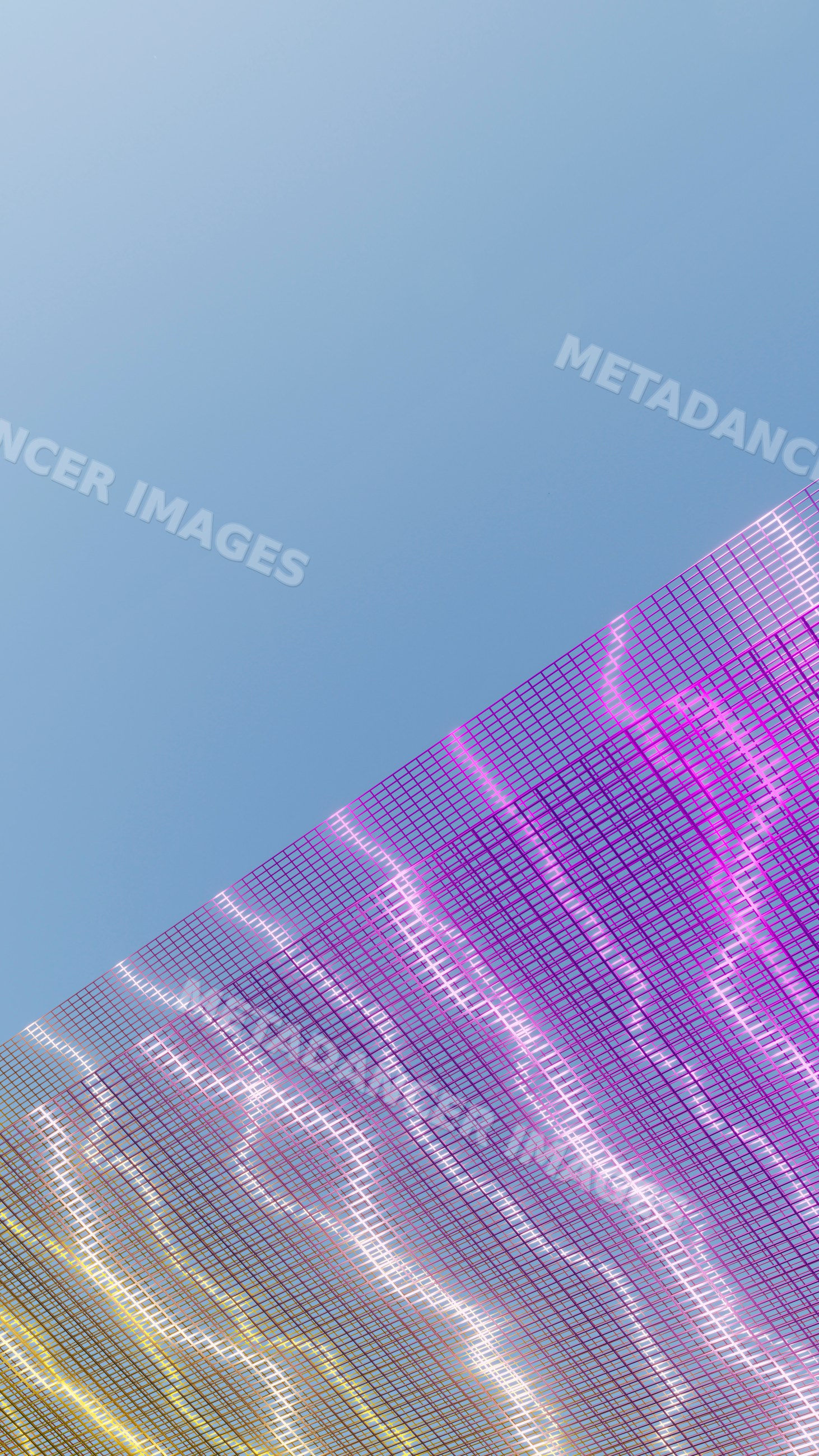 Mesh fabric with purple and yellow hues against clear blue sky