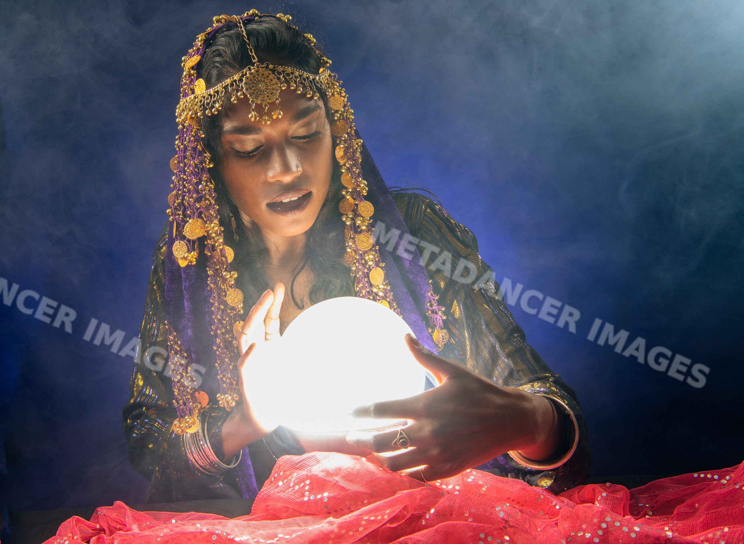 A fortune teller gazes into a glowing crystal ball