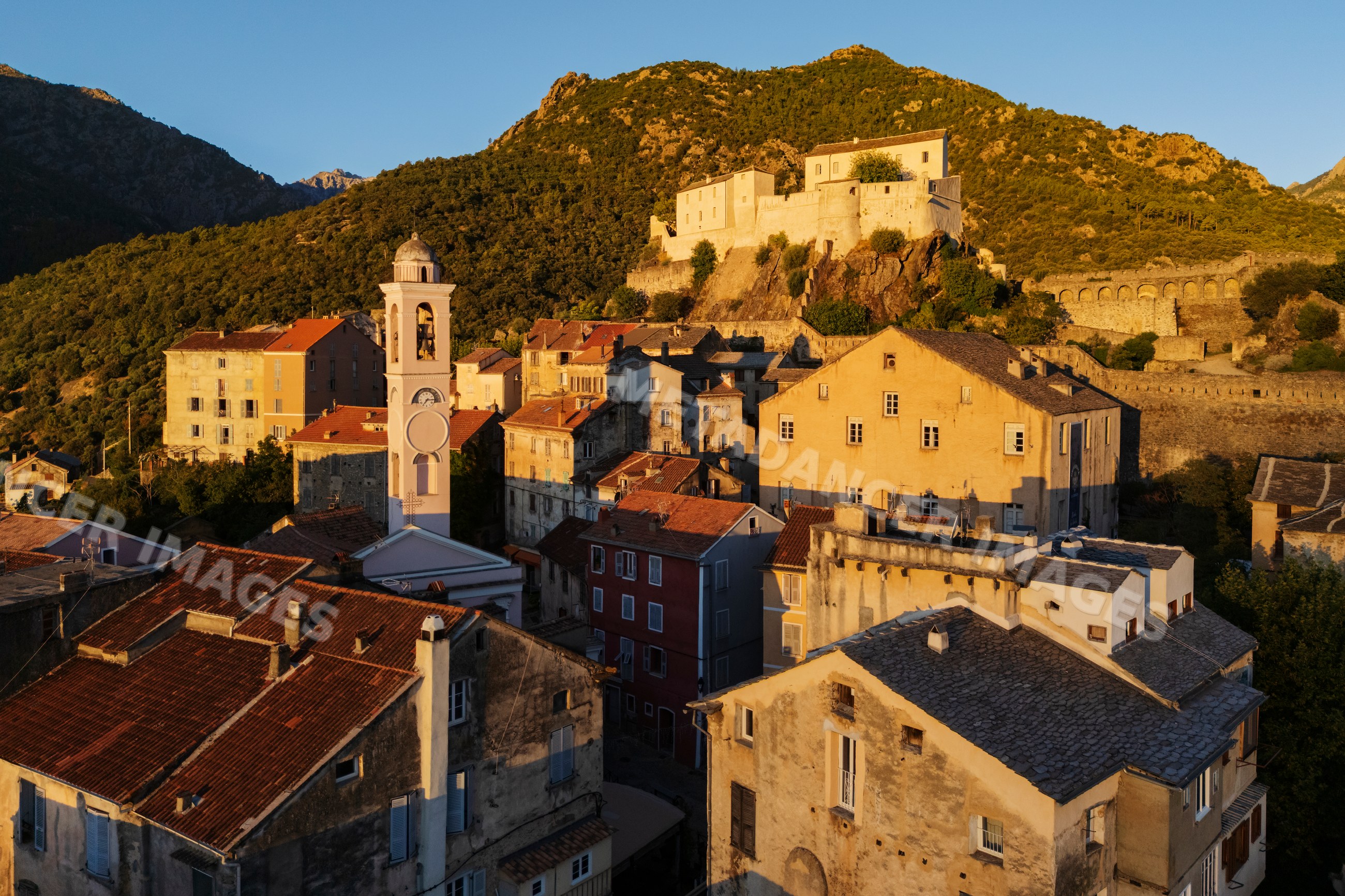 Town of corté with castle and church tower at Sunrise in corsica
