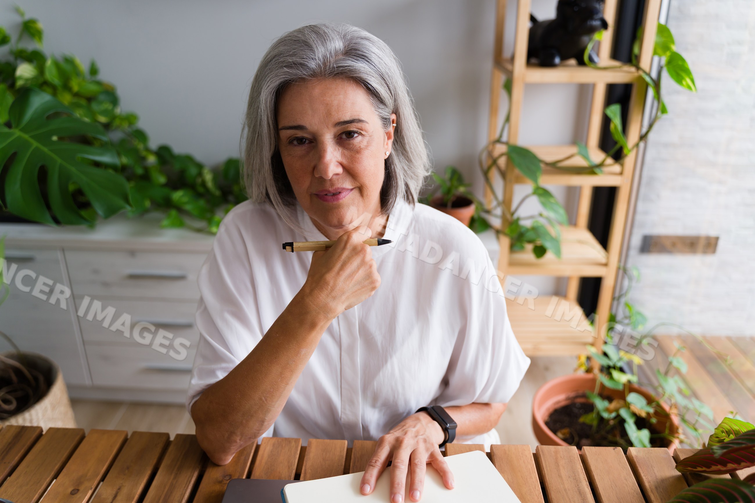 Mature white woman holding pen