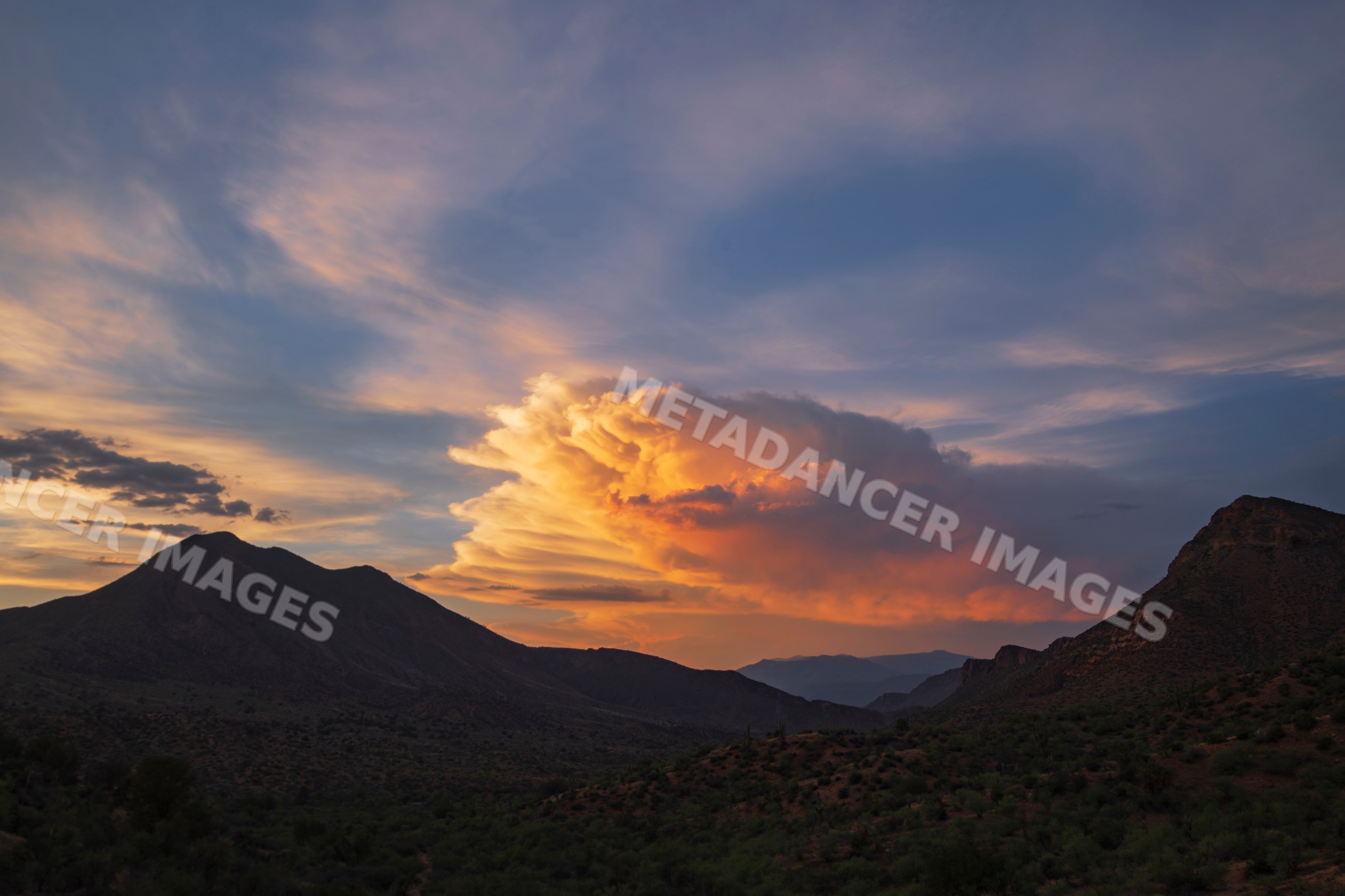 Thunderstorm cloud at Sunset over globe mountains
