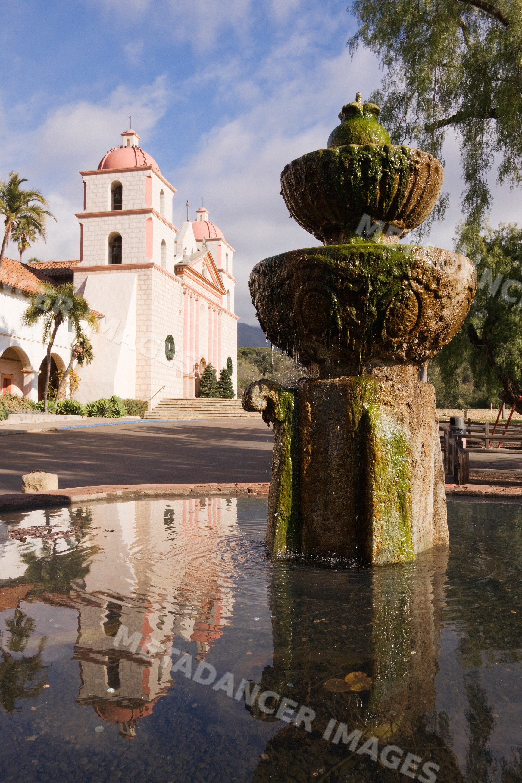 Santa barbara mission with fountain and reflection