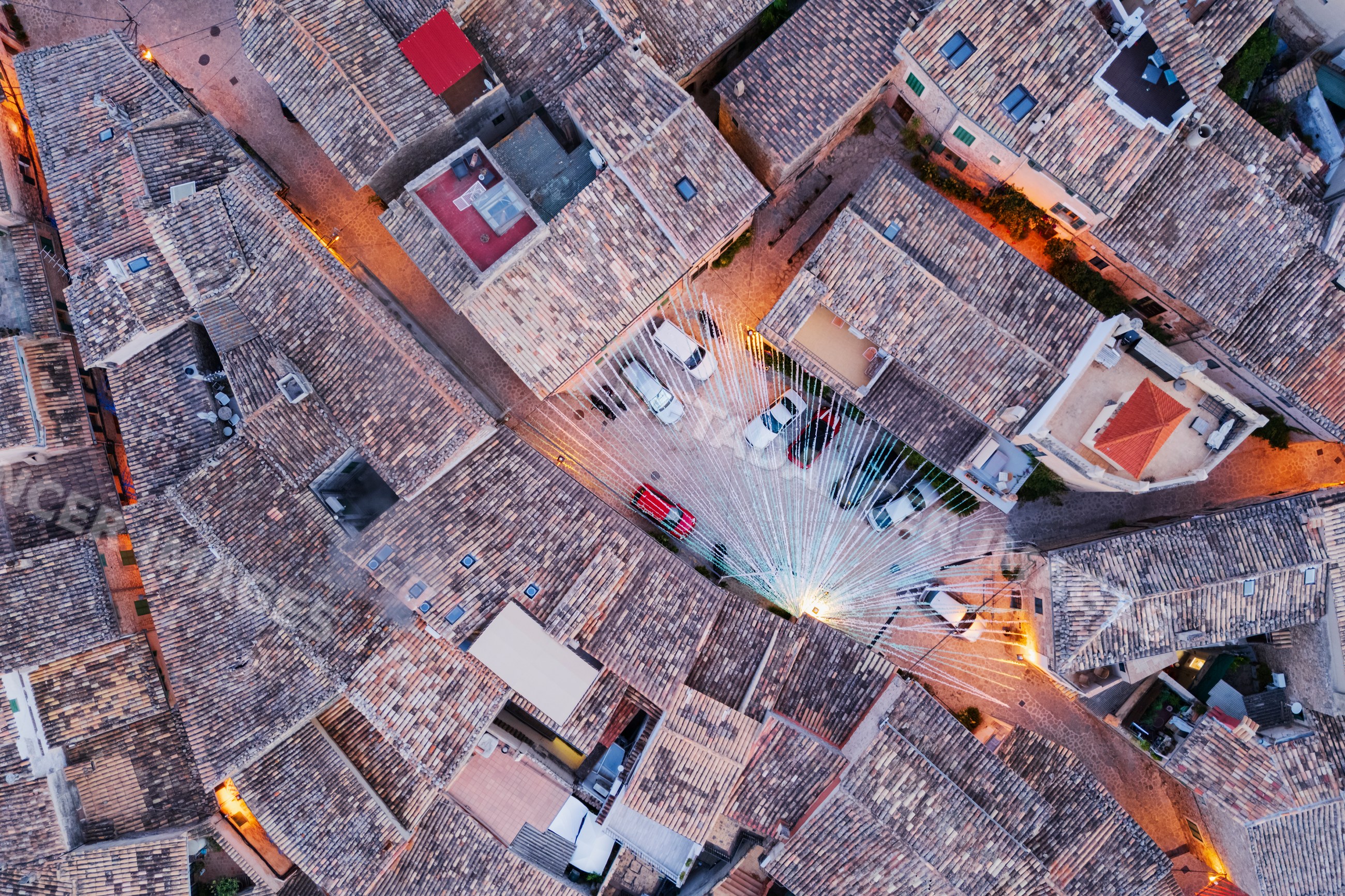 Aerial view of Valdemossa village rooftops with string lights