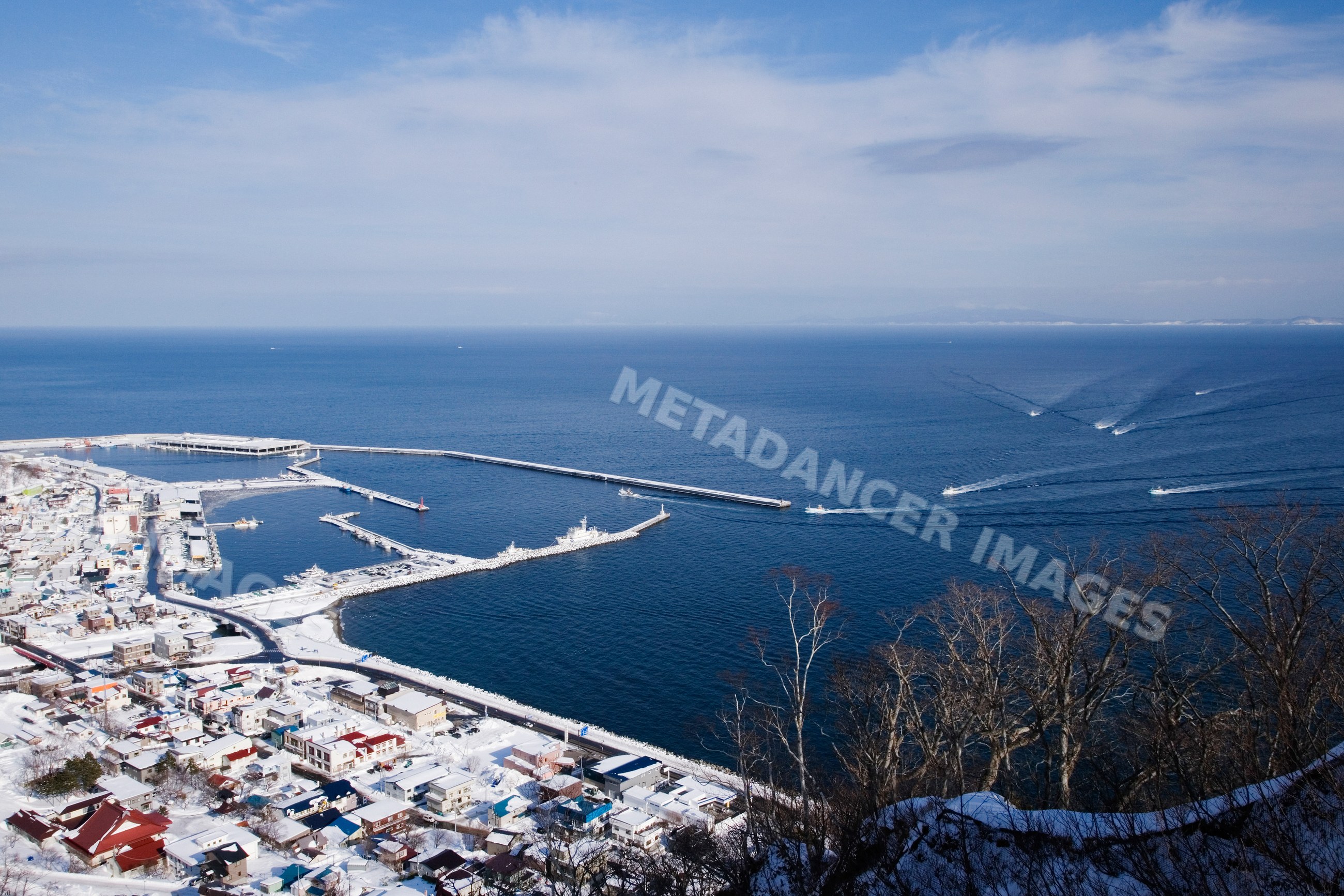 Fishing fleet in snowy harbor, hokkaido, japan