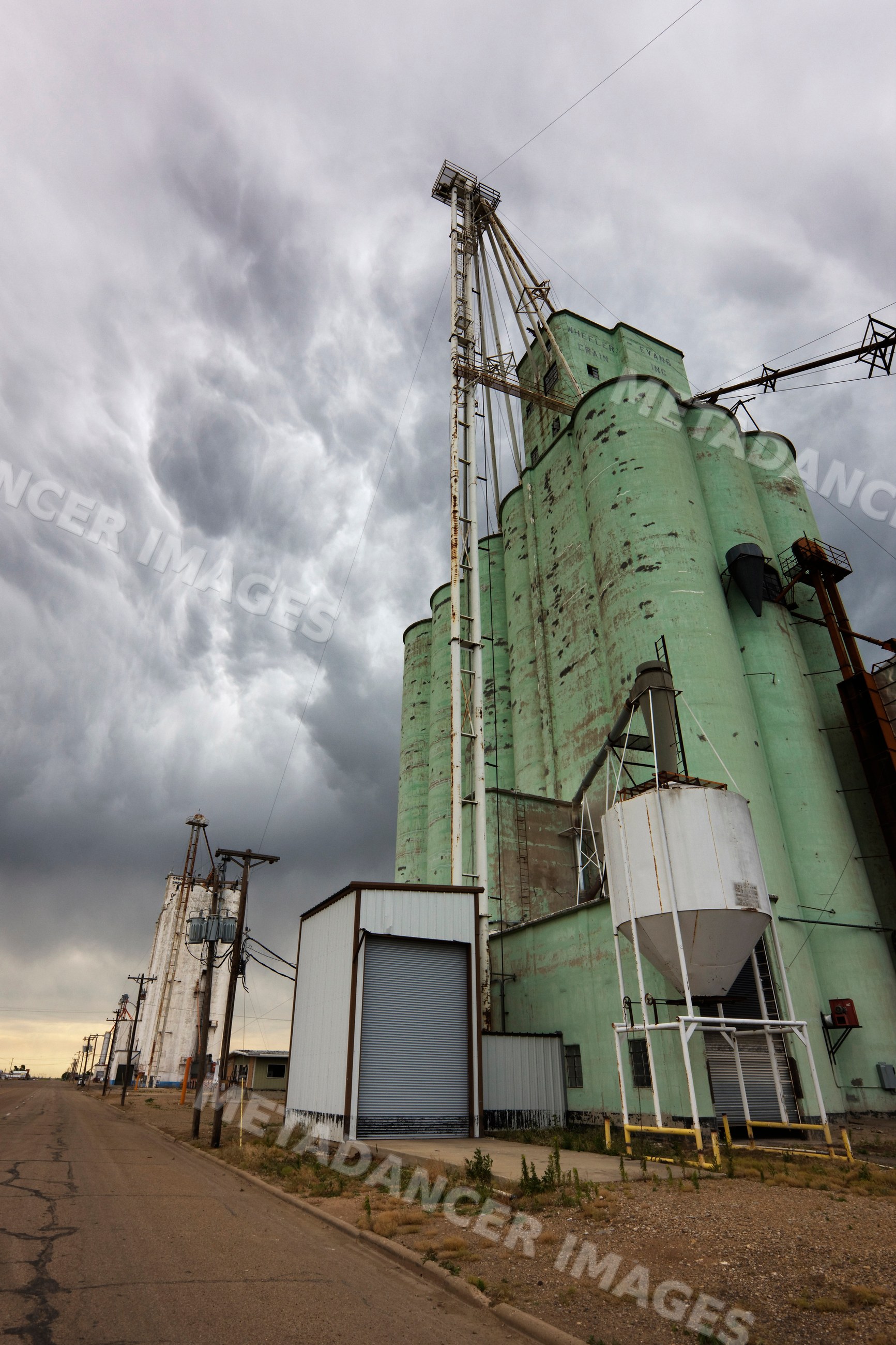 Grain elevator and storage silos under storm clouds