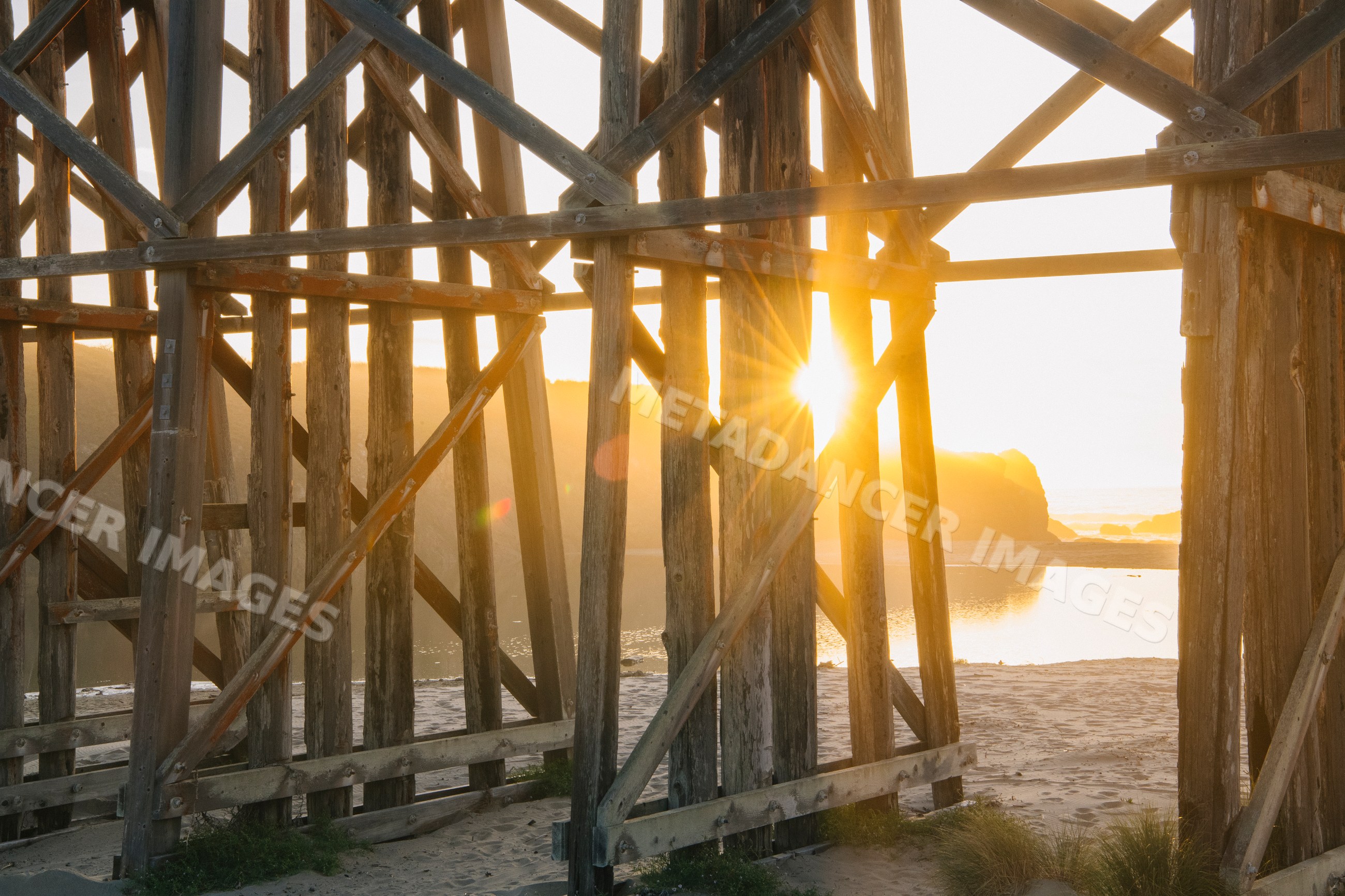 Sunlight through wooden beams on northern Oregon beach coast