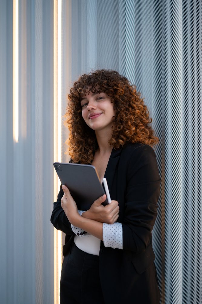 Young businesswoman holding digital tablet in modern office in Madrid