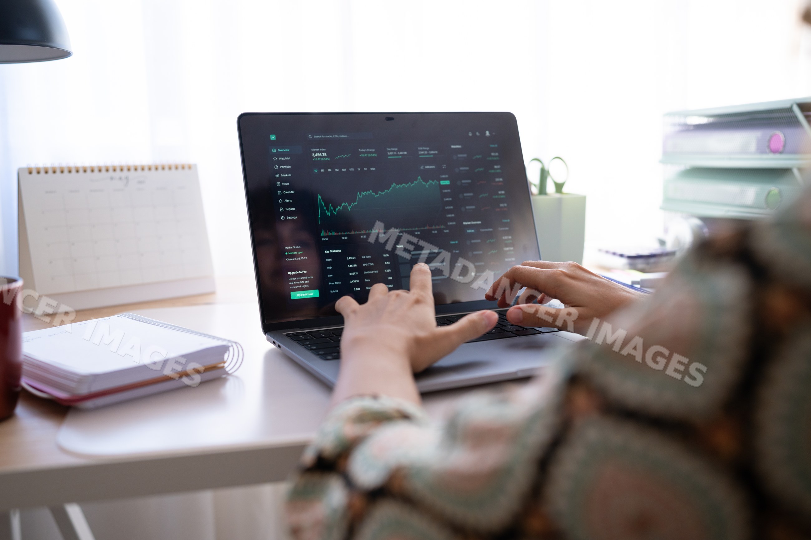 Stock market analysis on laptop in home office setting