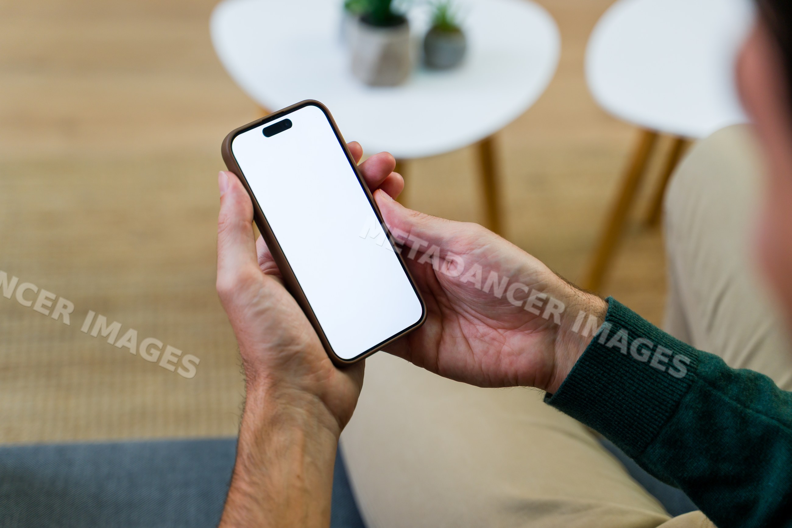 Man holding smartphone with blank white screen