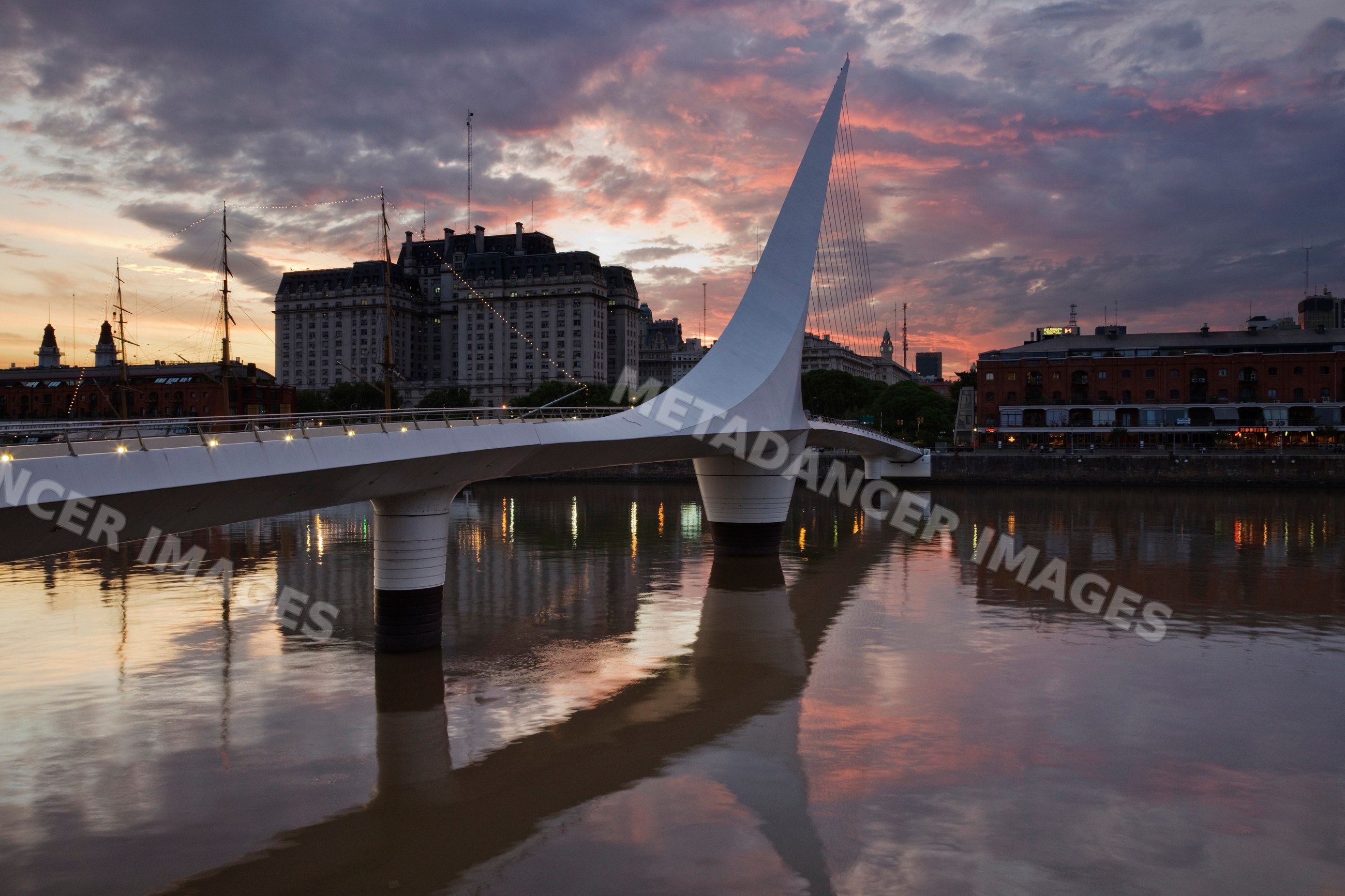 Puente de la mujer cable-stayed bridge at sunset waterfront