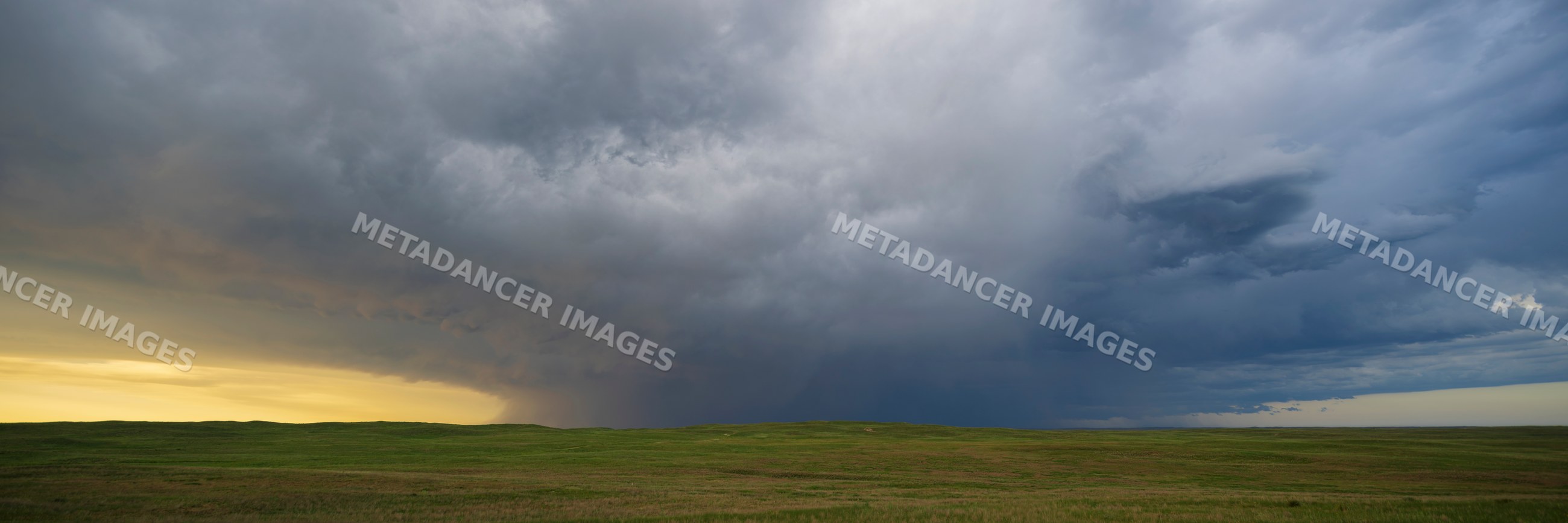 Receding Storm clouds over prairie landscape