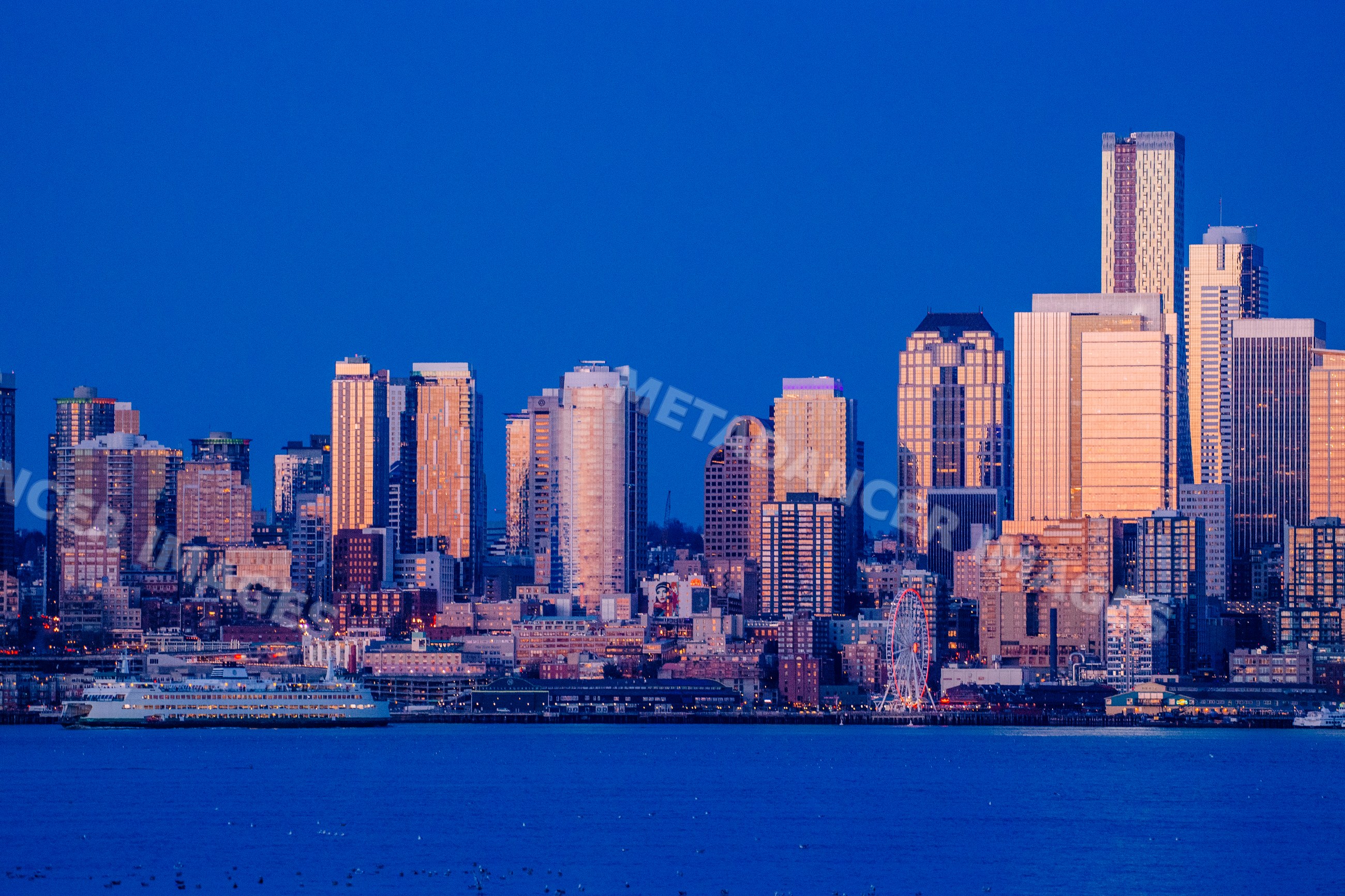 Seattle city skyline with ferry and waterfront at dusk