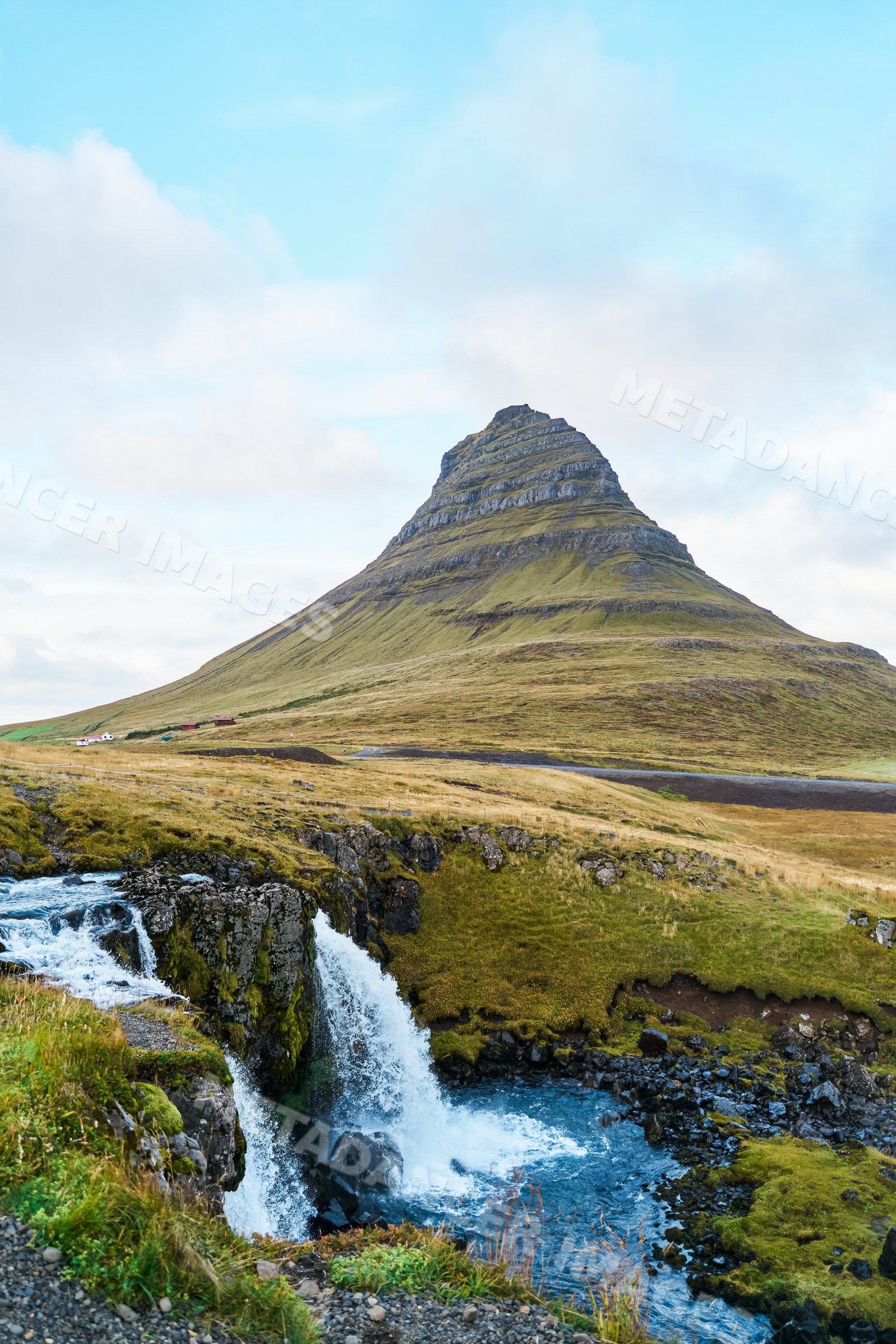 Mountain seen behind a waterfall in the natural landscape of Iceland