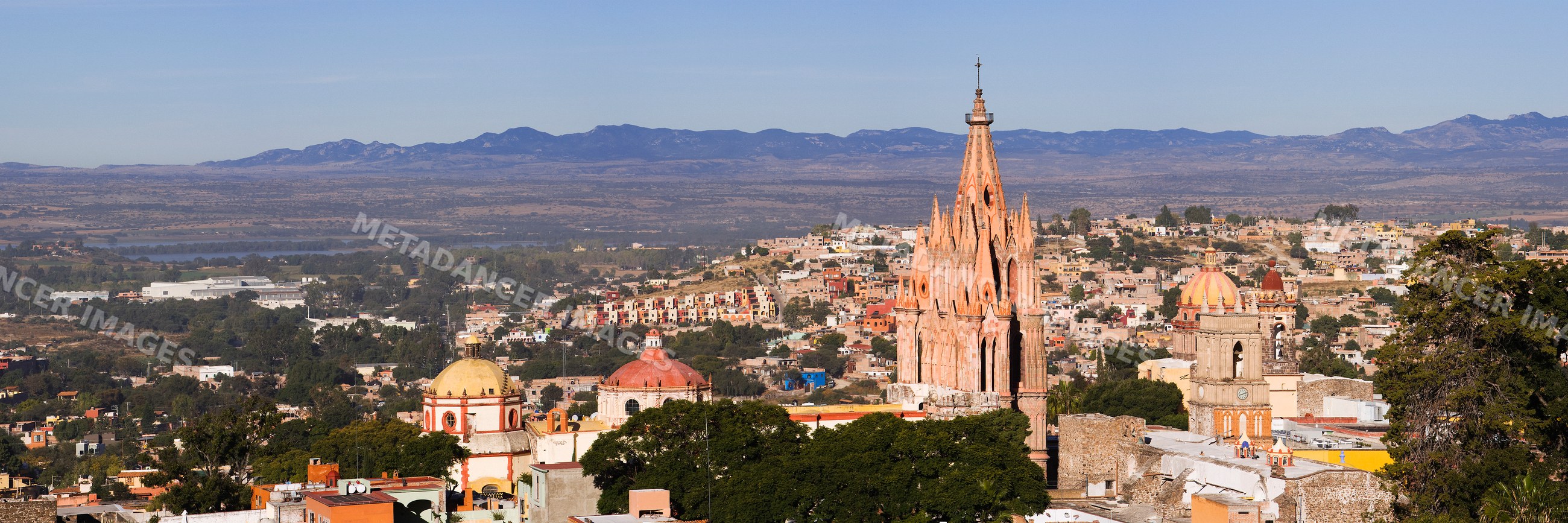 San miguel de allende cityscape with church towers and mountains