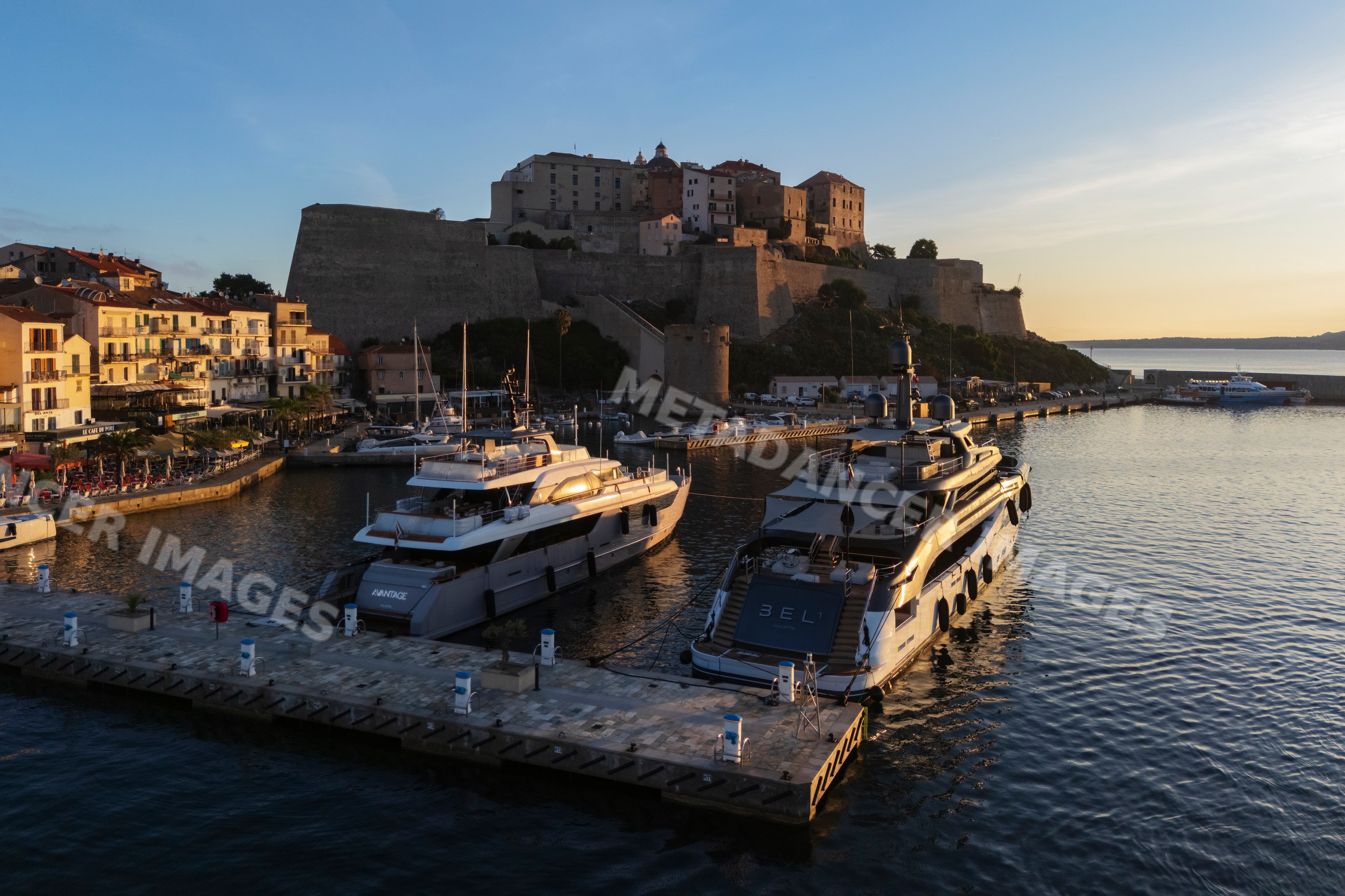 Citadel overlooking harbor with yachts at Sunrise in calvi, corsica