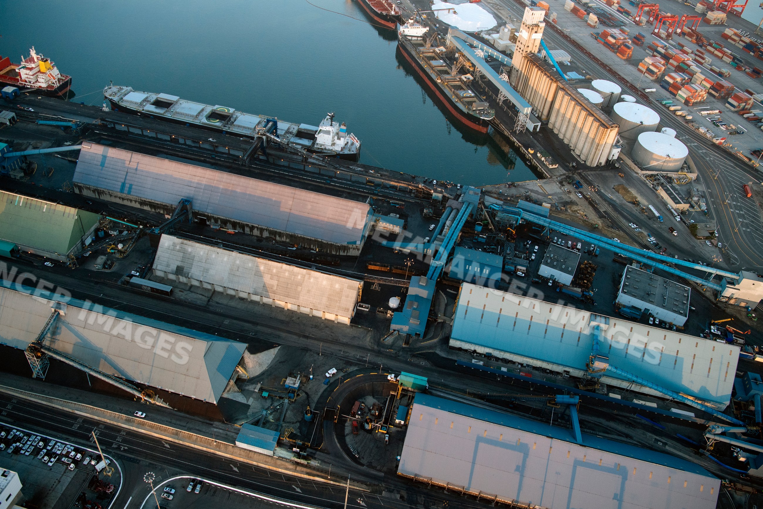 Aerial view of container port with ships, warehouses, and shipping