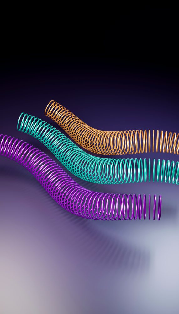 Curved colorful coil spring toy trio against gradient background