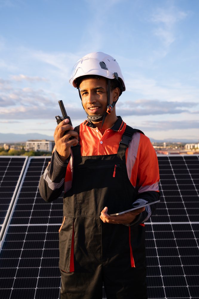 Technician uses devices on solar panel installation