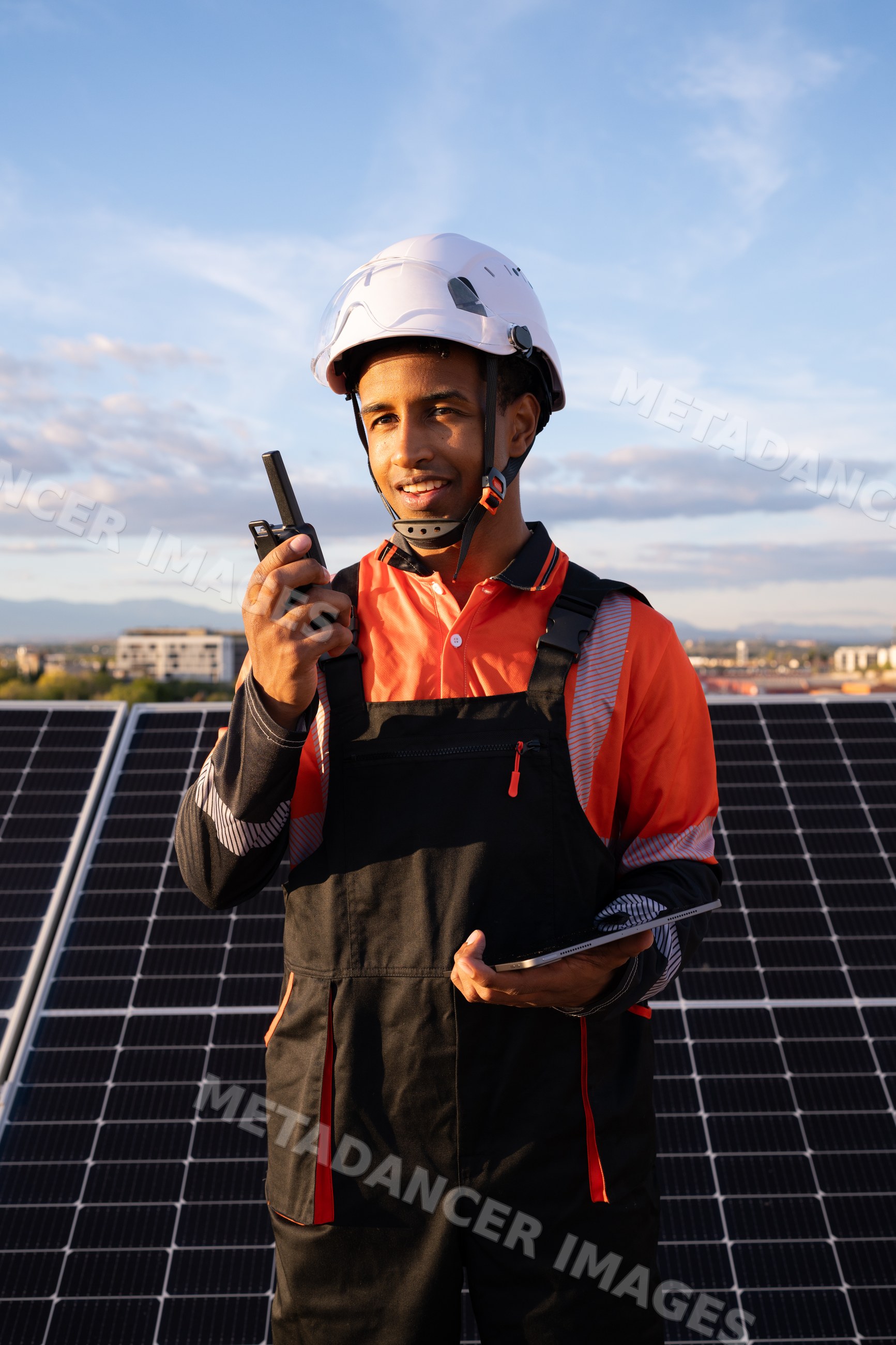 Technician uses devices on solar panel installation