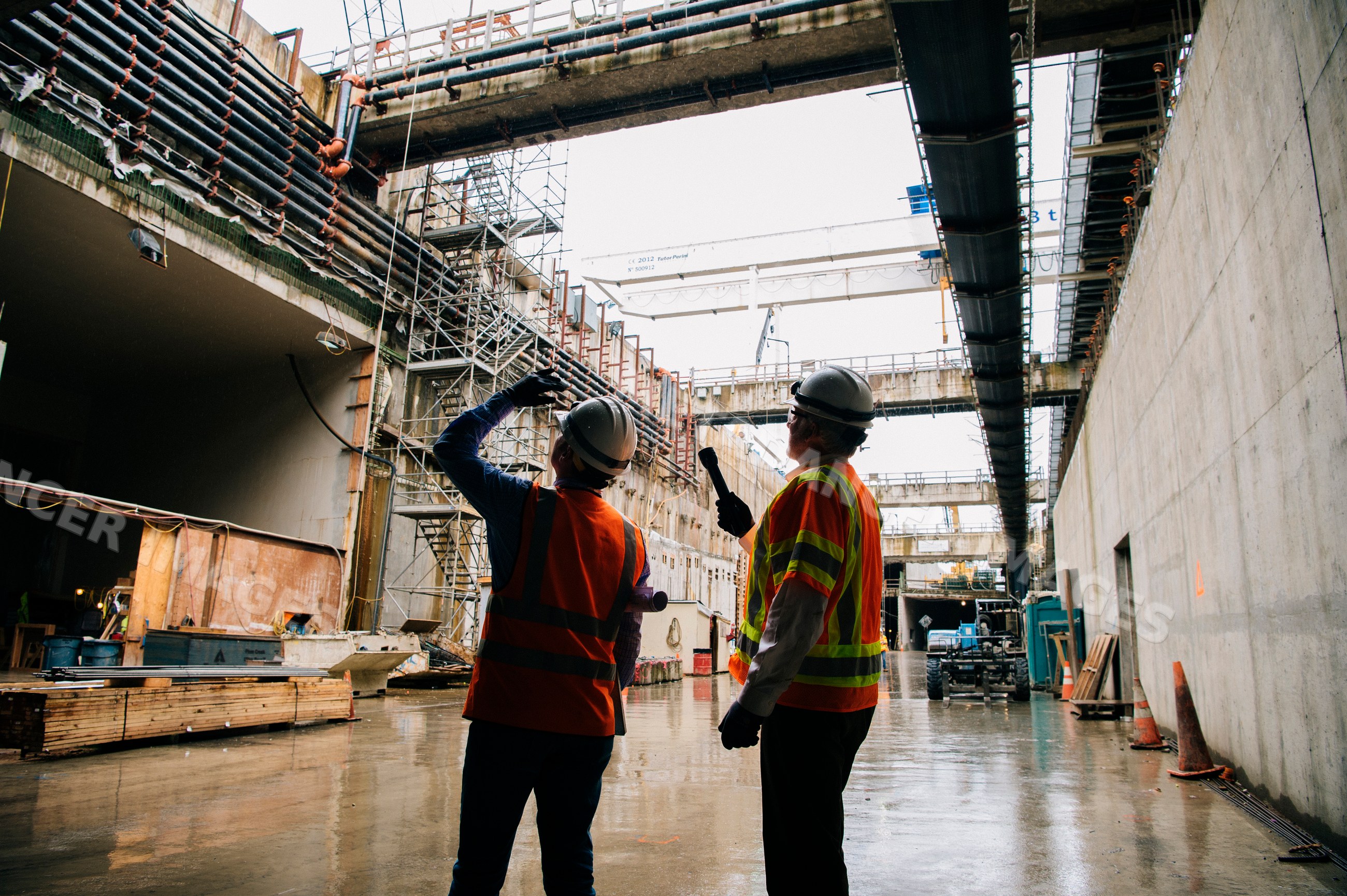 Two construction white workers discuss progress