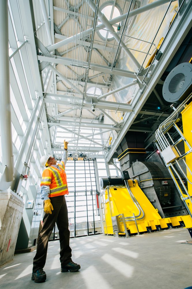 White construction worker points