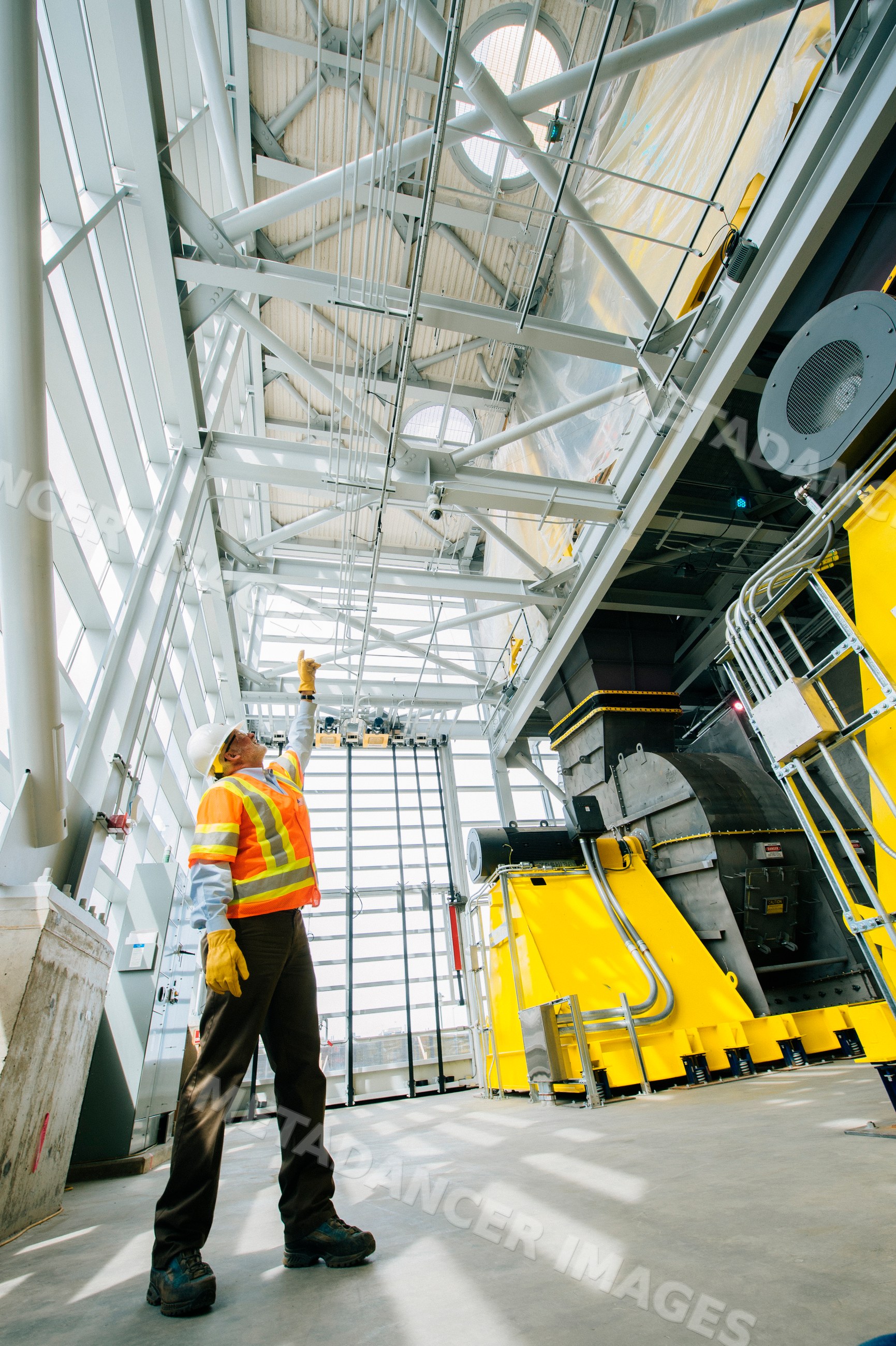 A construction white worker points